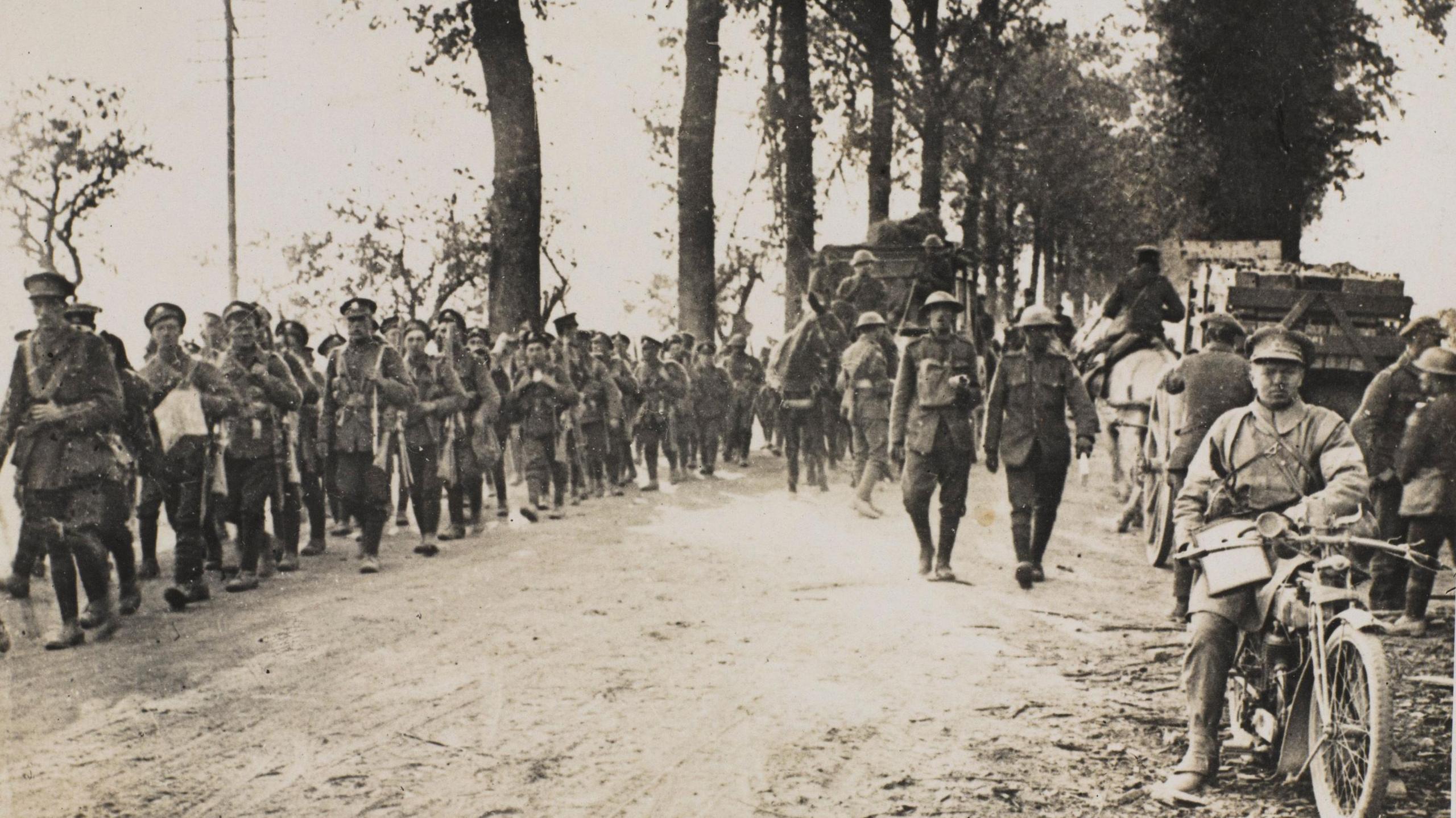 Black-and-white photograph  of the Manchester Regiment on the march in 1918