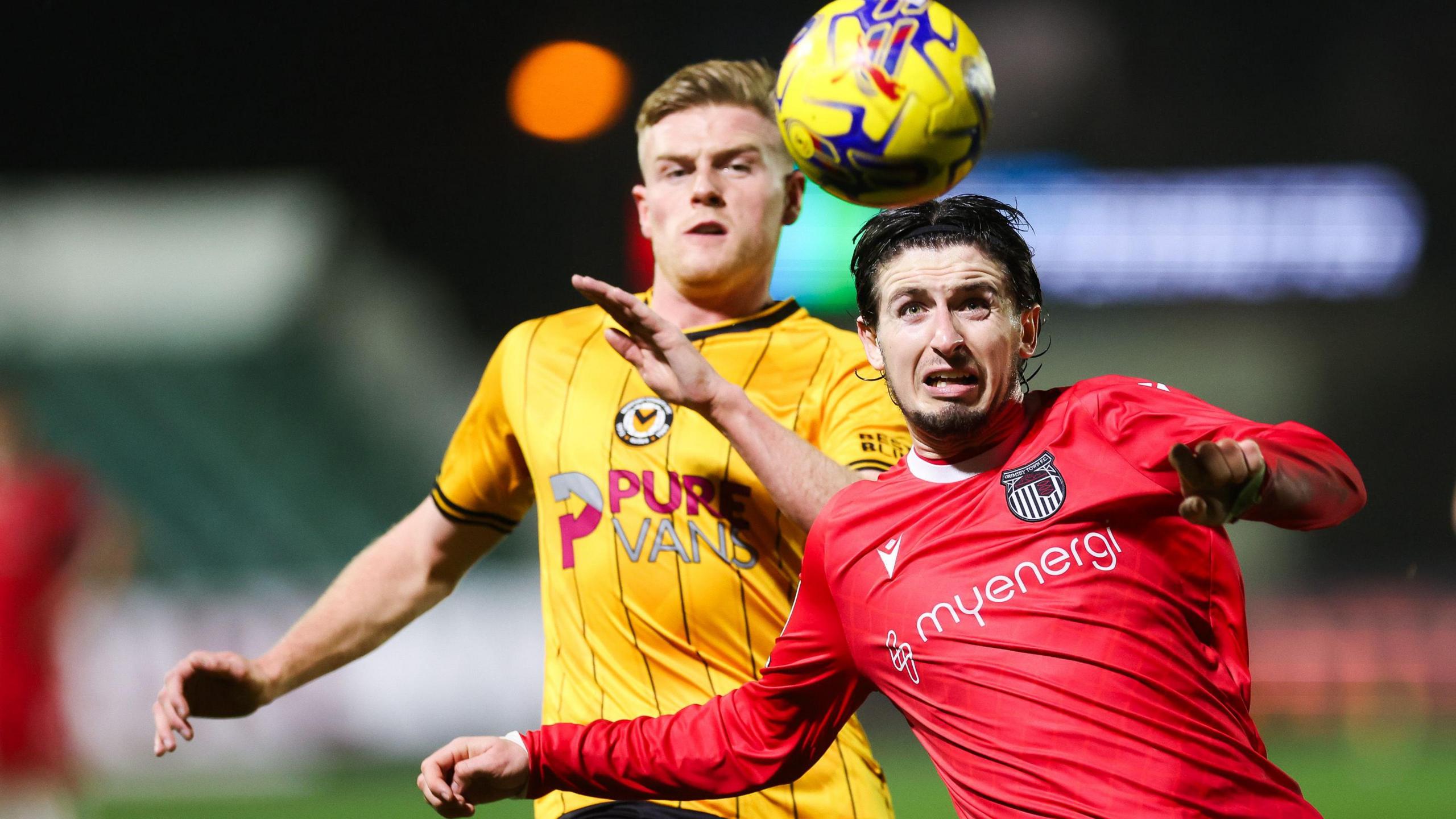 Will Evans of Newport County and Anthony Glennon of Grimsby compete for the ball