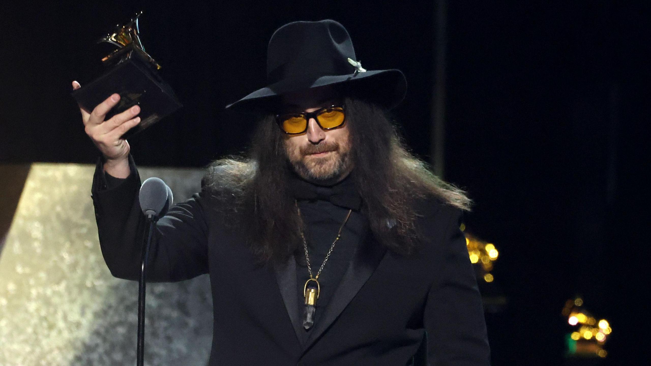 Sean Ono Lennon holding up a Grammys trophy