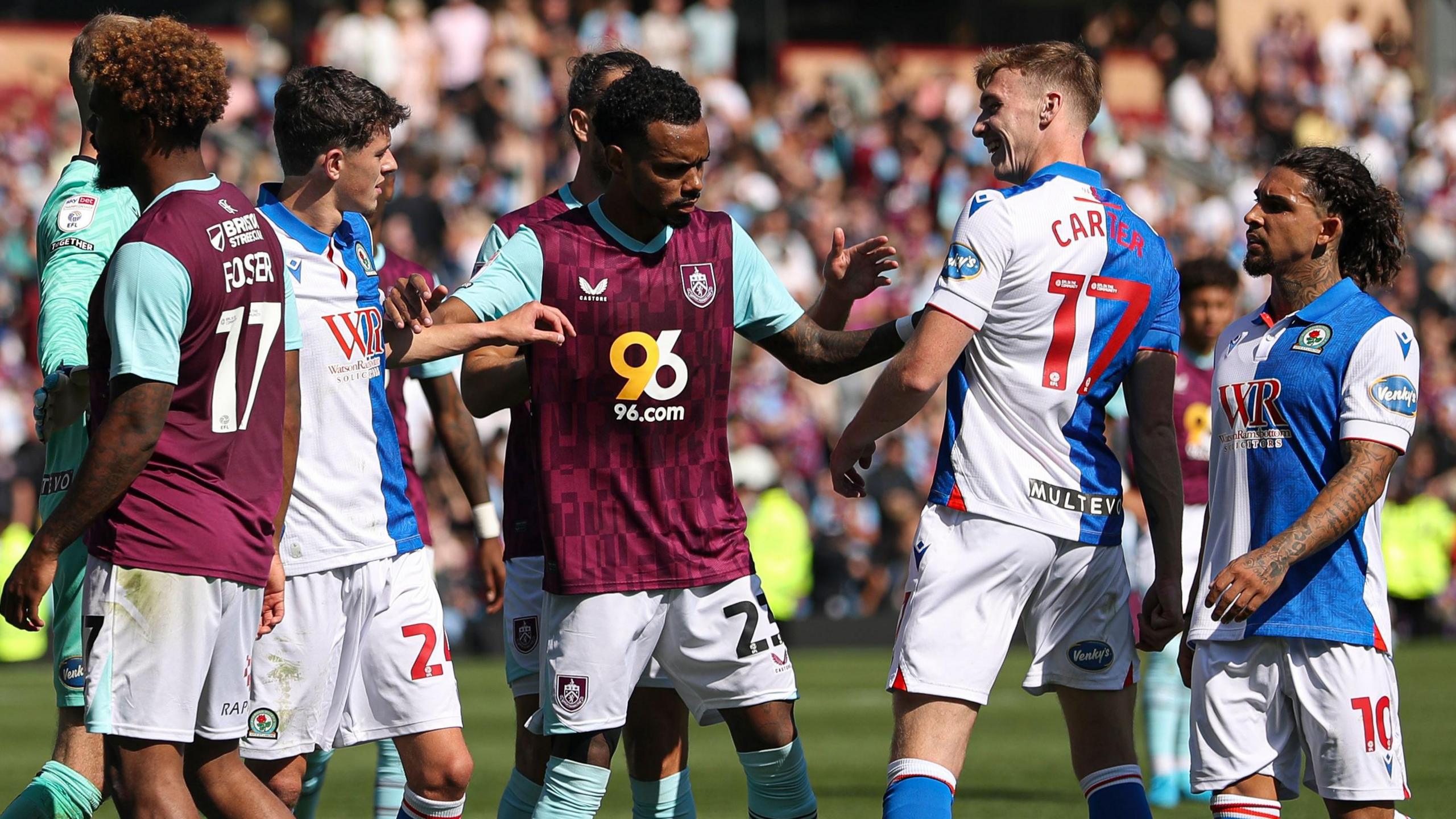 Burnley and Blackburn players clash in their Championship match in August 2024