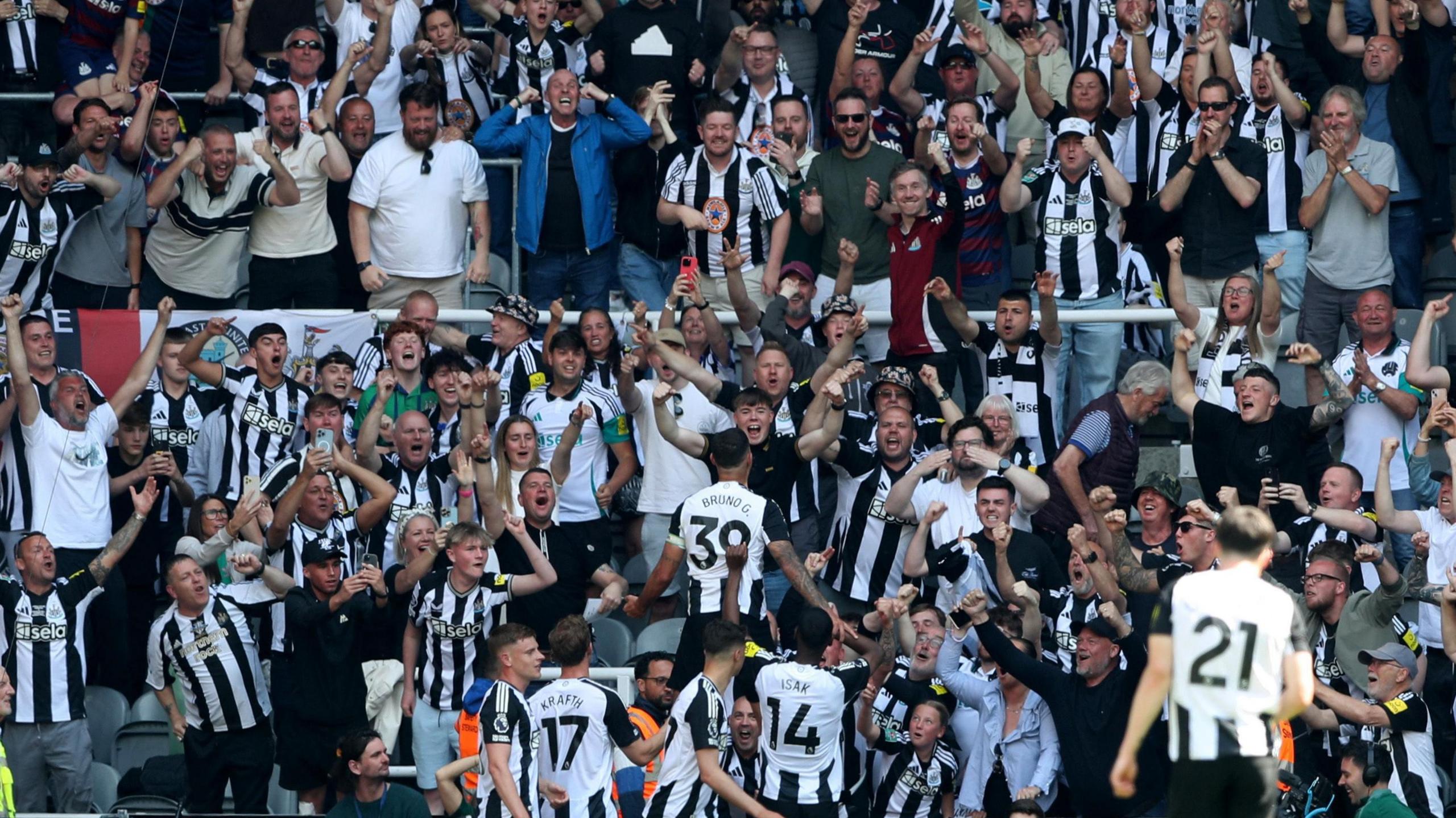 Newcastle United's Bruno Guimaraes celebrates scoring their second goal with teammates during the Newcastle United v Chelsea at St James' Park on 11 May 2025. Fans in the stands are smiling and cheering. 