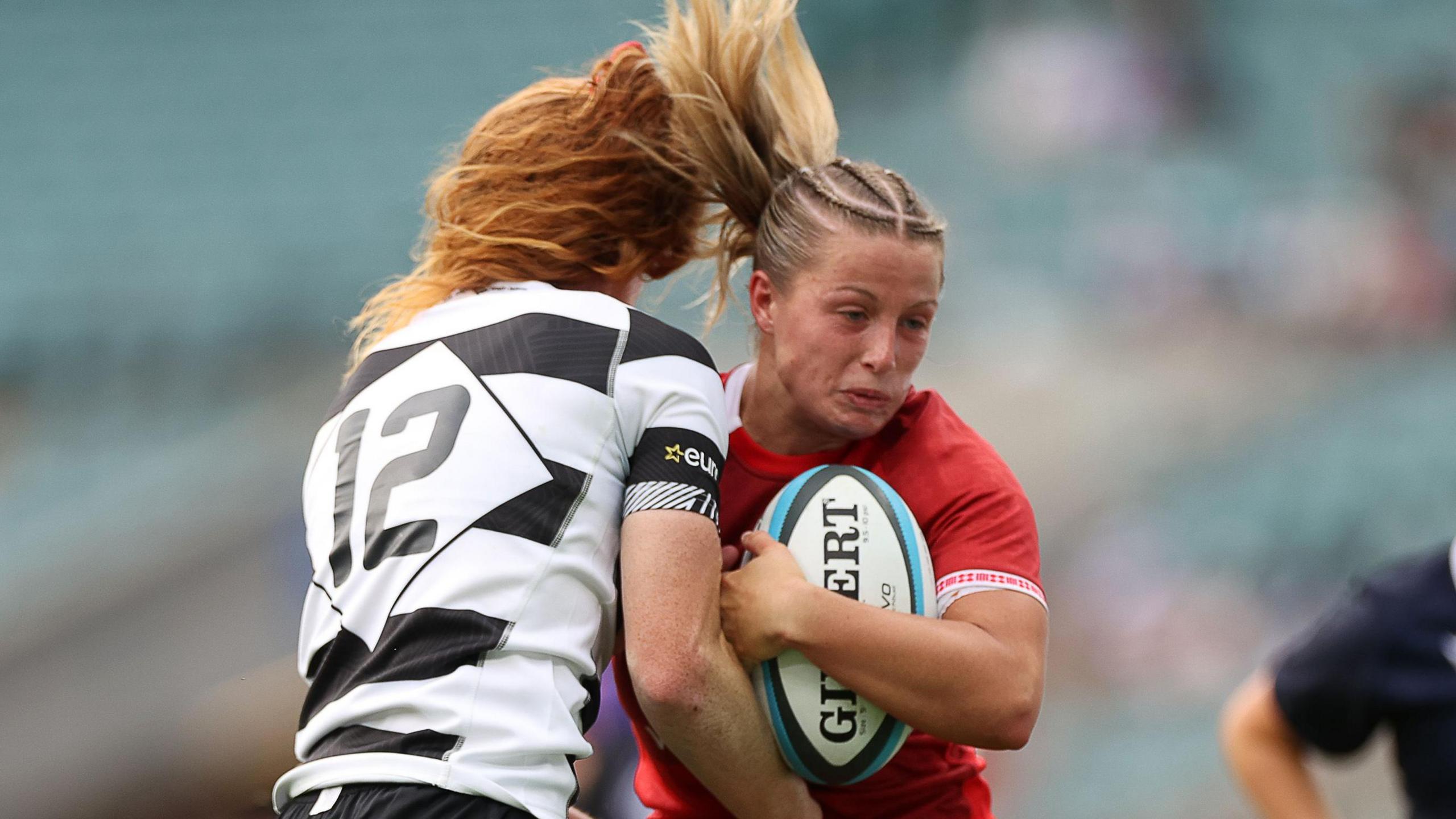 Amy Williams runs at Alex Tessier in Wales' fixture against Barbarians at Twickenham