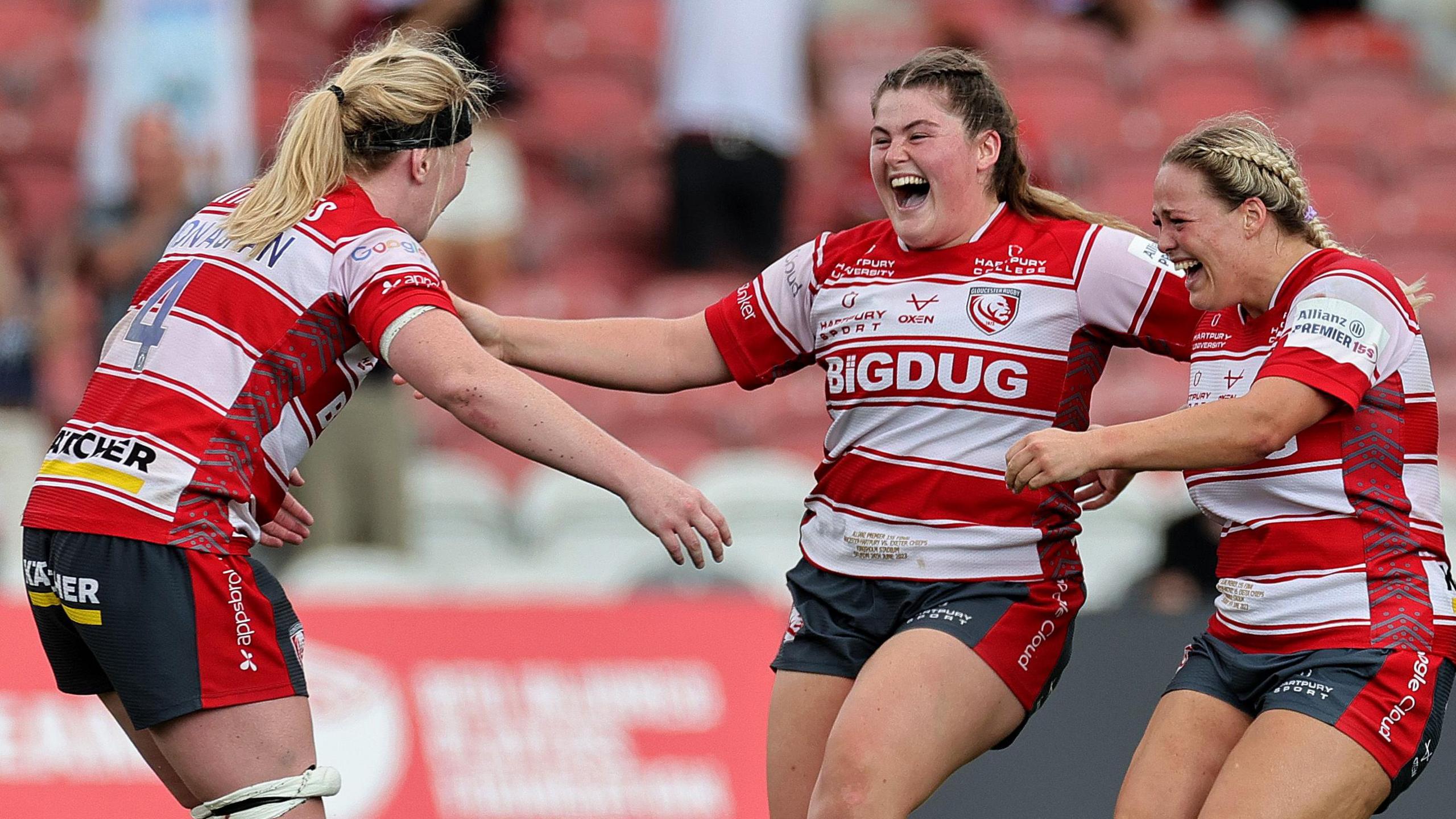 Maud Muir (centre) celebrates with two team-mates after the final whistle in the semi-final