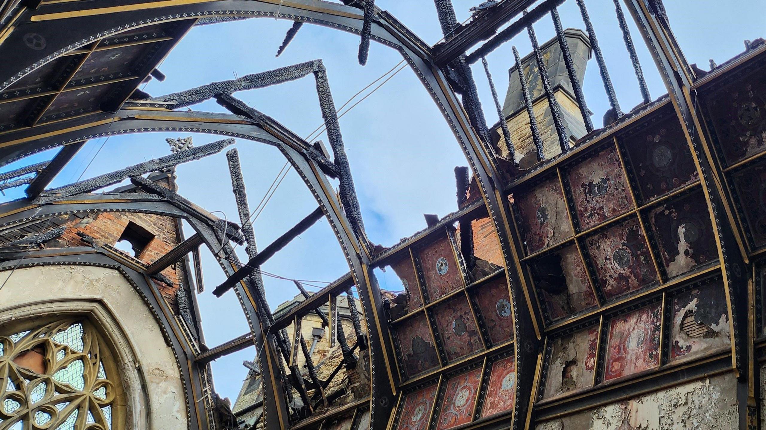 The charred remains of the former Junior Seminary Chapel of St Aloysius at St Cuthbert's College. The sky is visible through the roof.