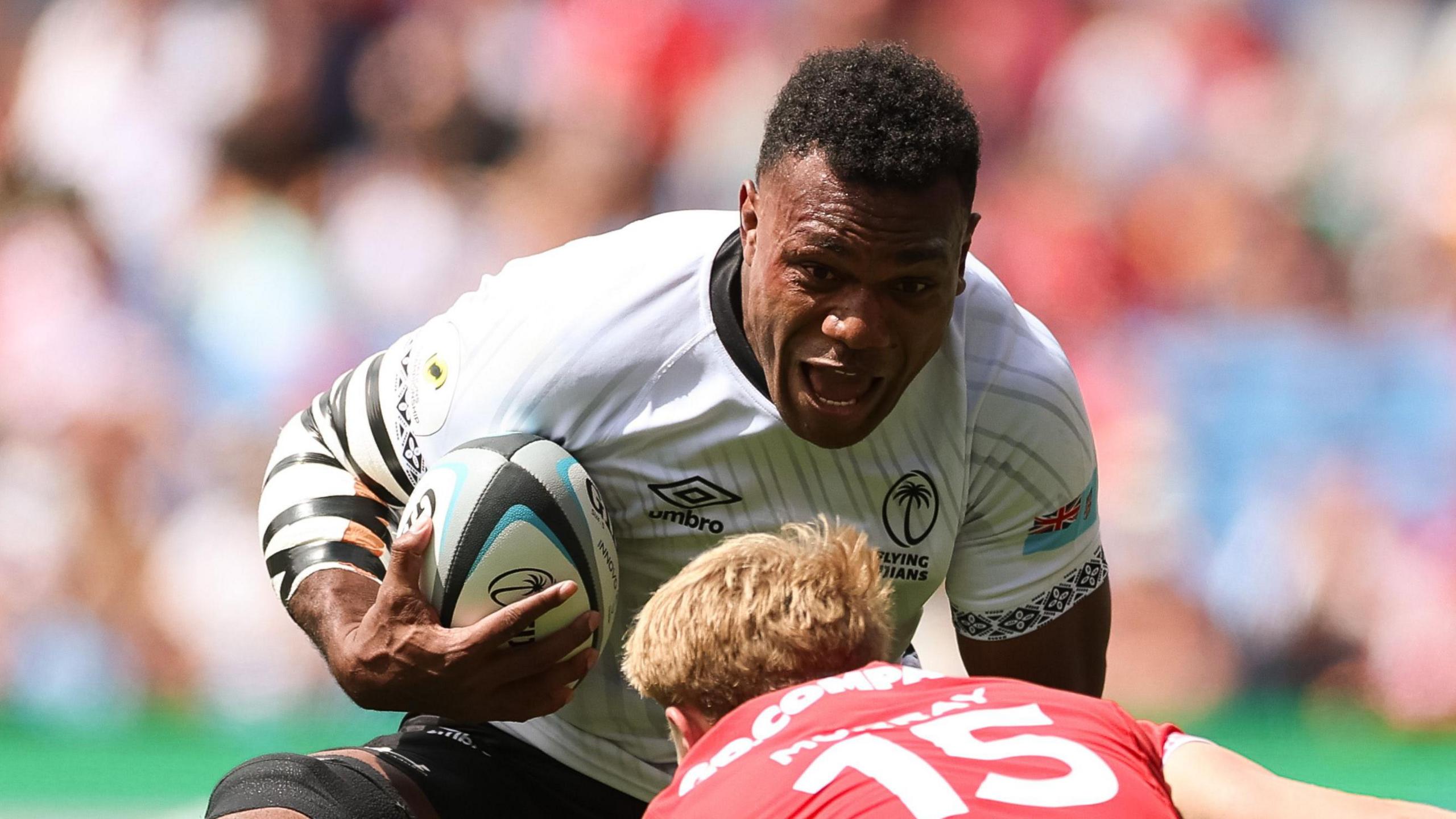 Fiji number eight Elia Canakaivata takes on Wales full-back Blair Murray