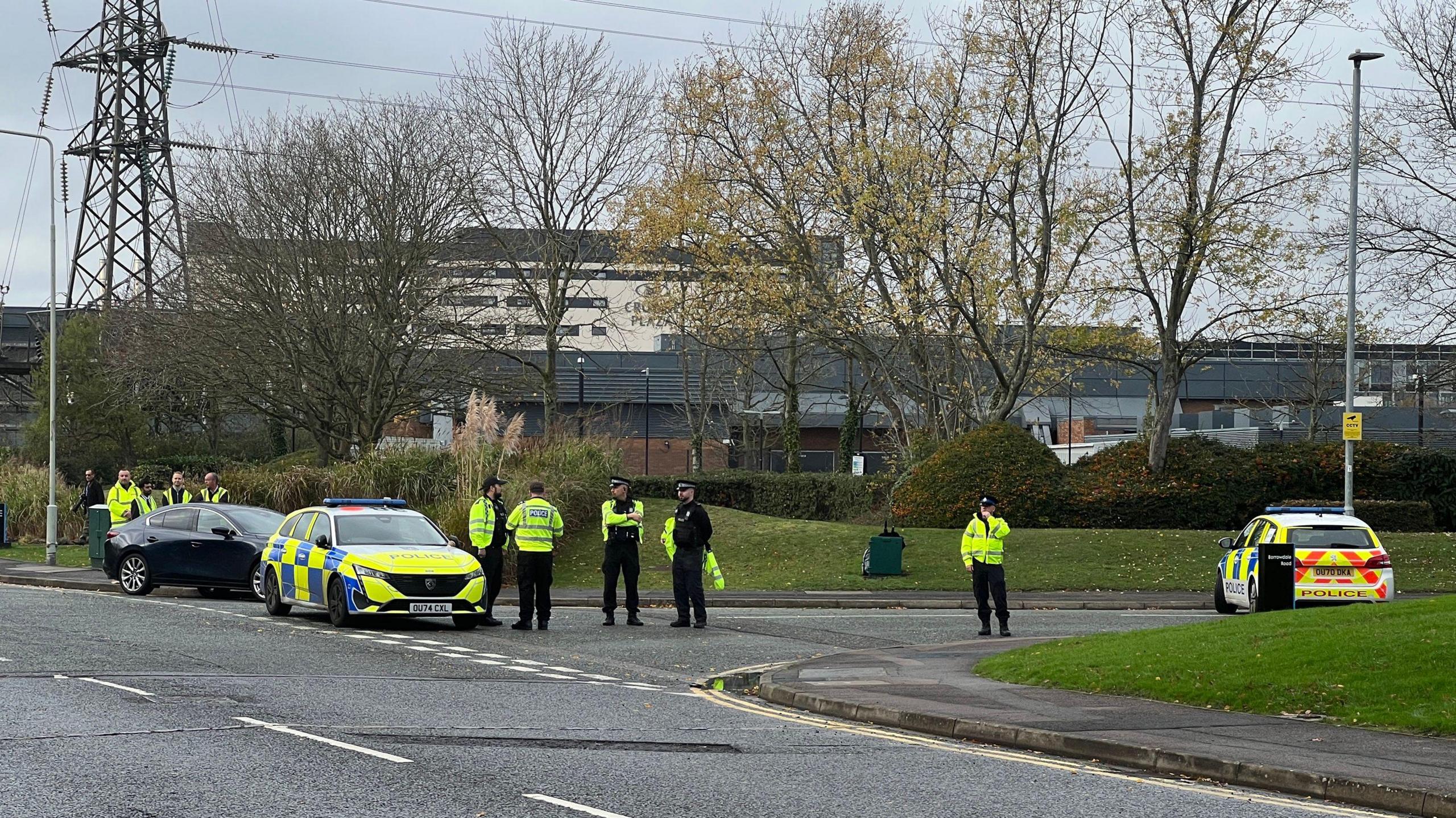 Police officers and police cars gathered at the junction of two roads in Winnersh on Wednesday morning.