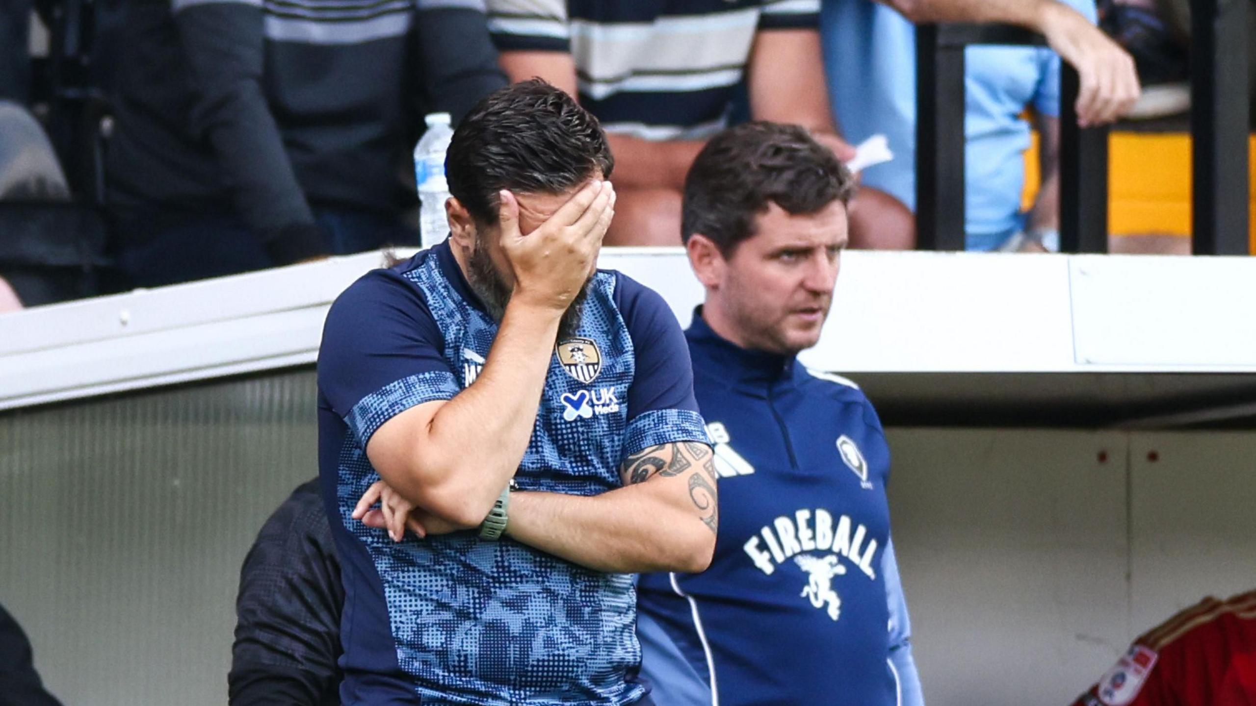 Notts County boss Martin Paterson with his hand on his head in frustration.