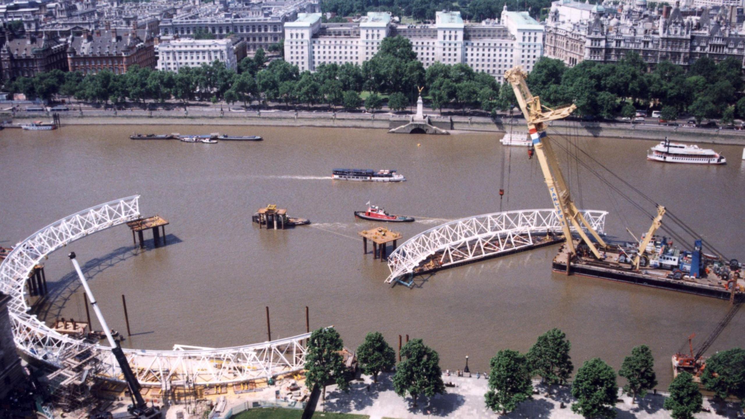 The River Thames and a crane lifting a part of the London Eye into position during construction in the late 1990s