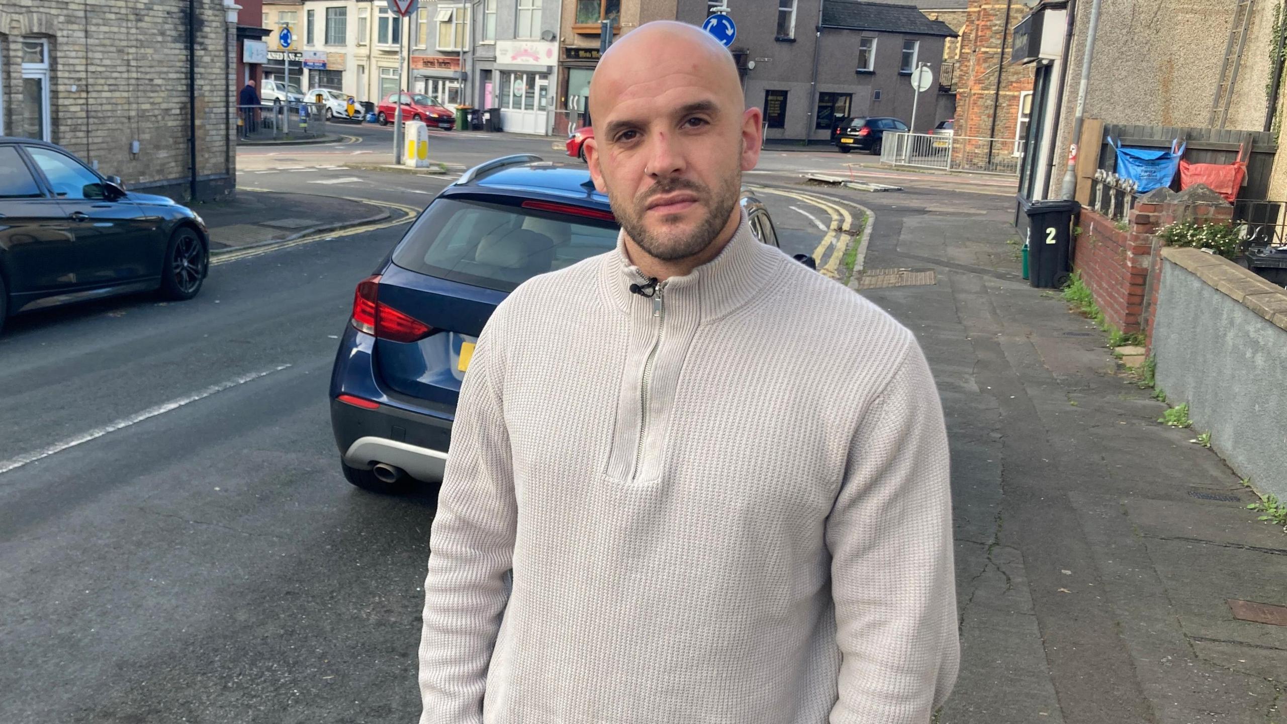 Sam Bevan standing next to a road