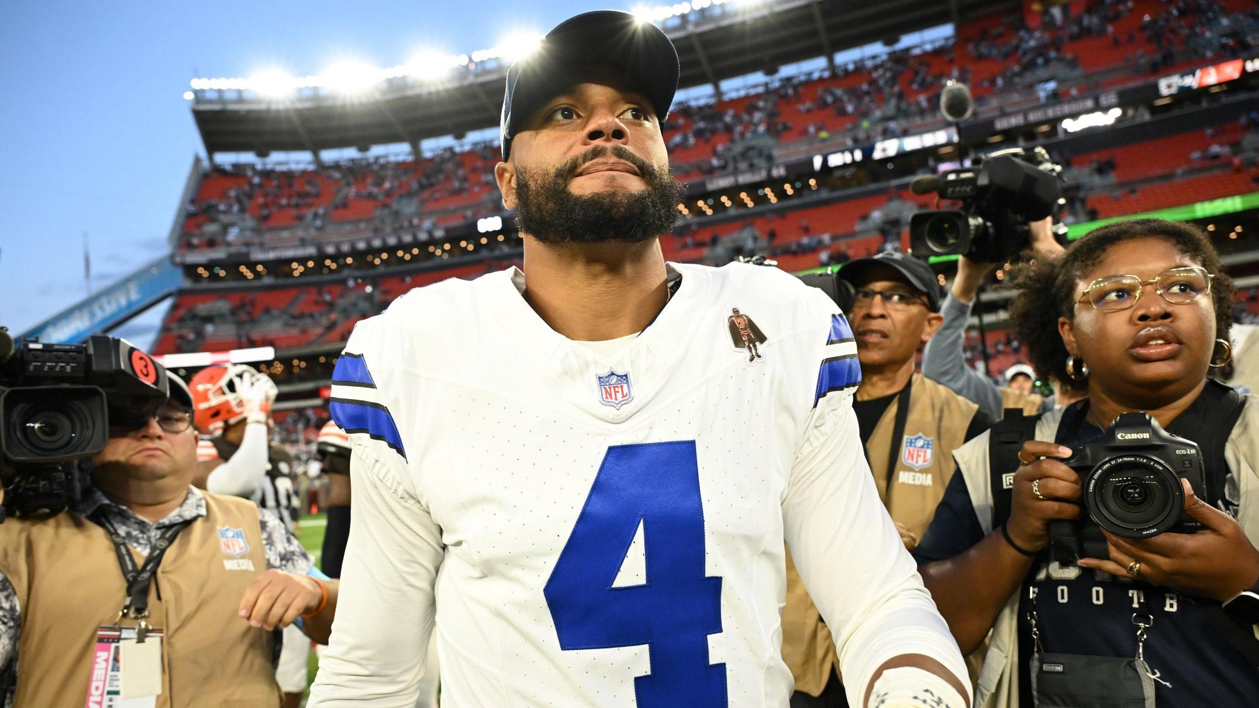 Dak Prescott of the Dallas Cowboys walks off the field after a game in Cleveland