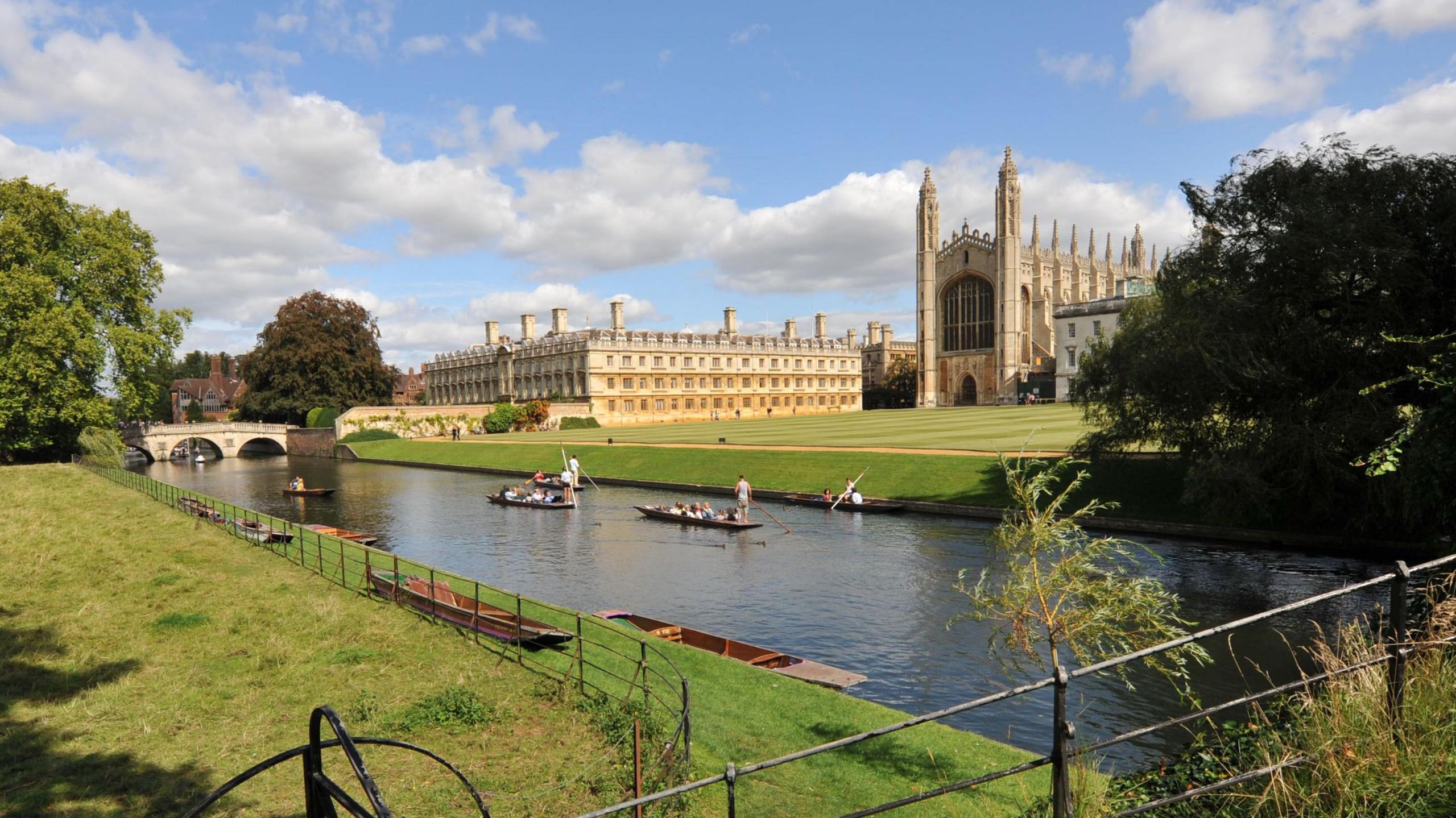 A punt makes its way along the River Cam against a backdrop of Cambridge University's King's College Chapel and Clare College in the spring sunshine.
