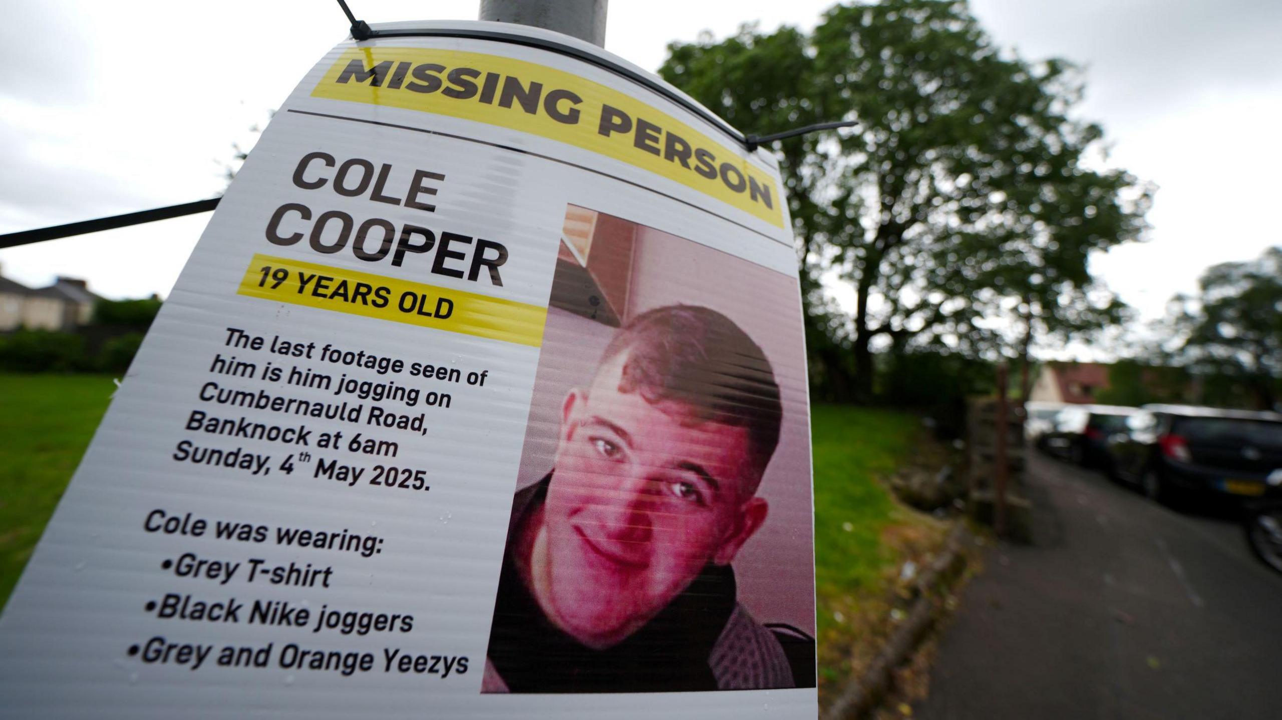 A close up of a missing person poster for Cole Cooper, taken on a lamp post in his local area. It carries a photo and a description of the teenager.
