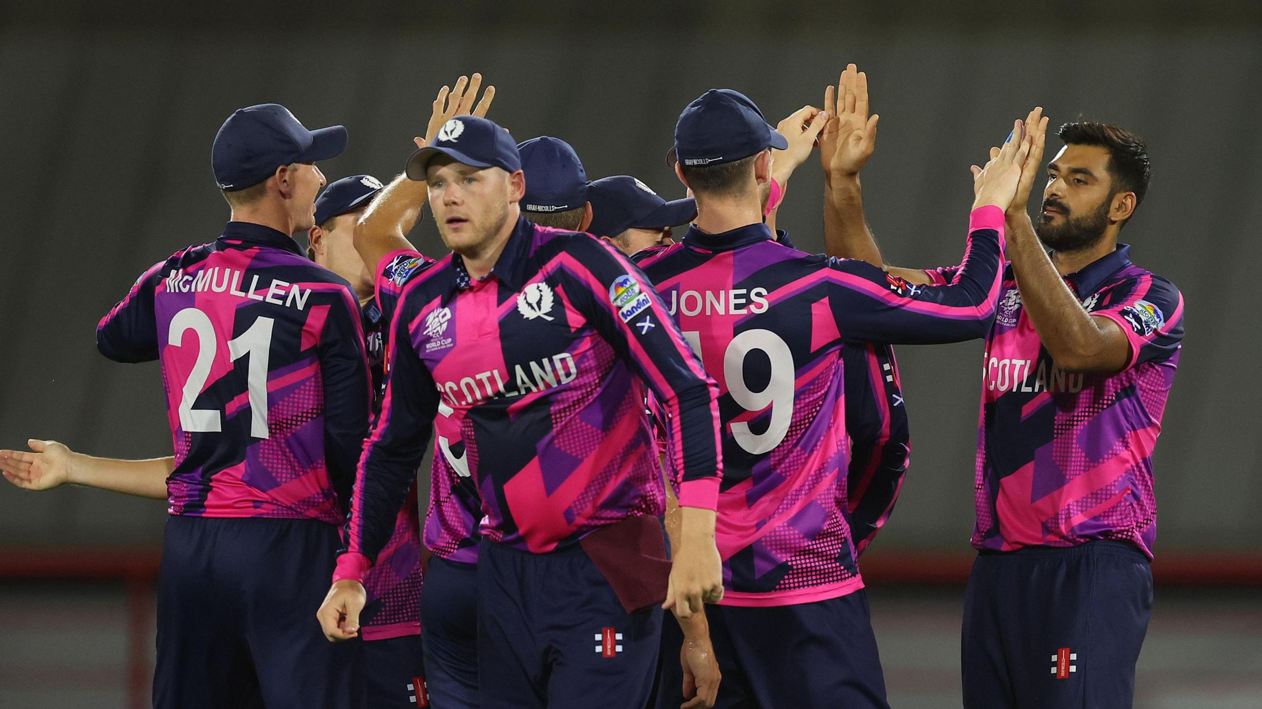 Safyaan Sharif of Scotland celebrates with team-mates after dismissing Mitchell Marsh of Australia during the ICC Men's T20 Cricket World Cup in 2024