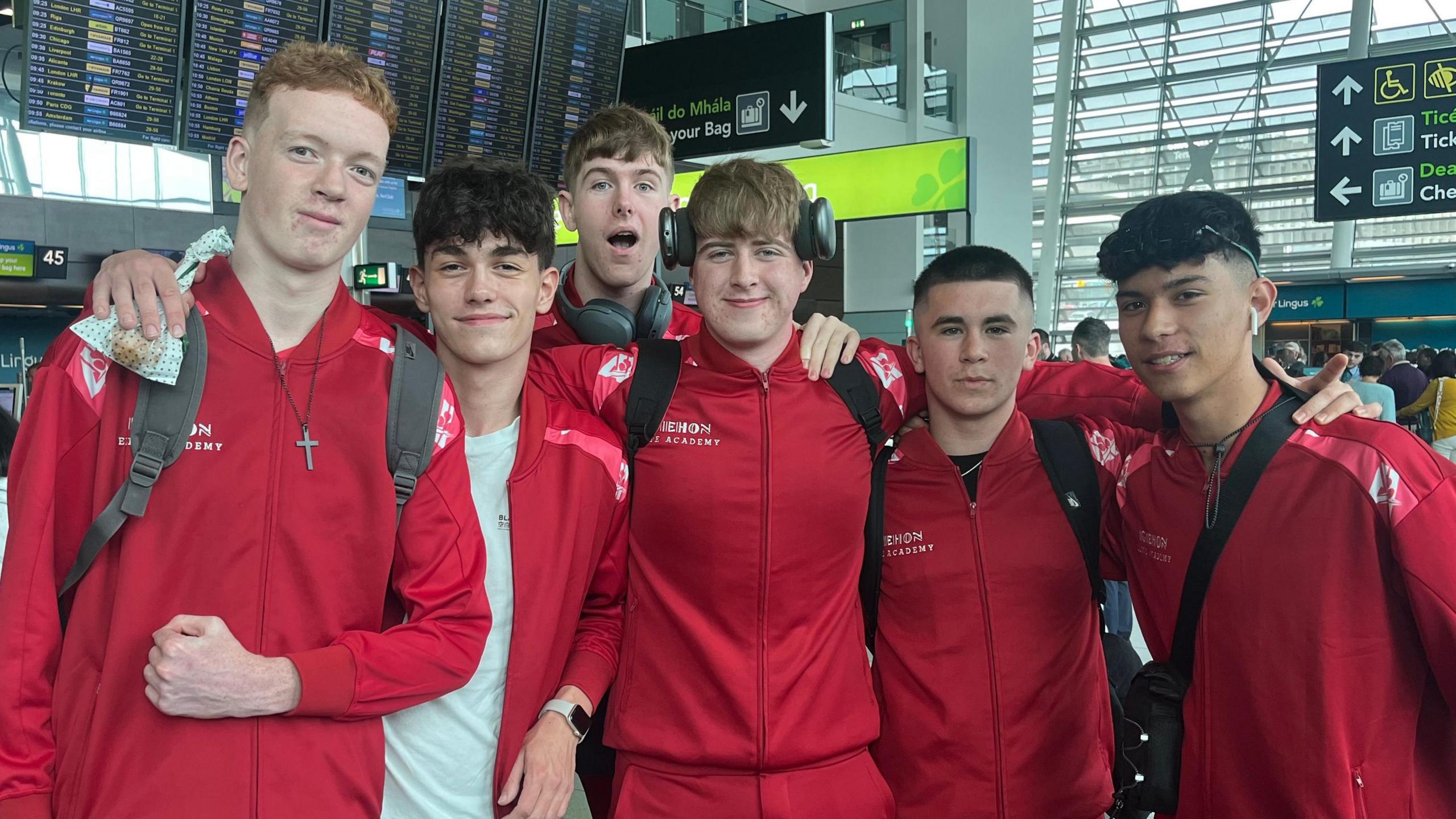 Six boys in red basketball tracksuits