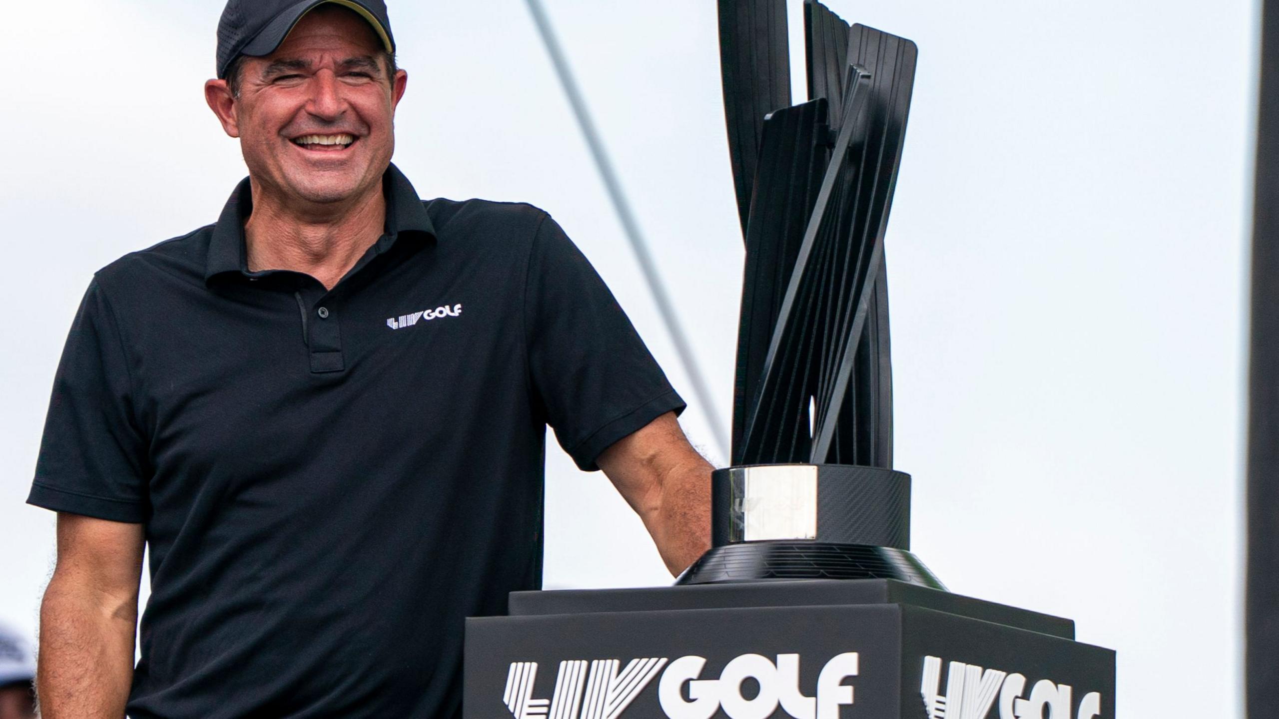 LIV Golf chief executive Scott O'Neill with a LIV trophy