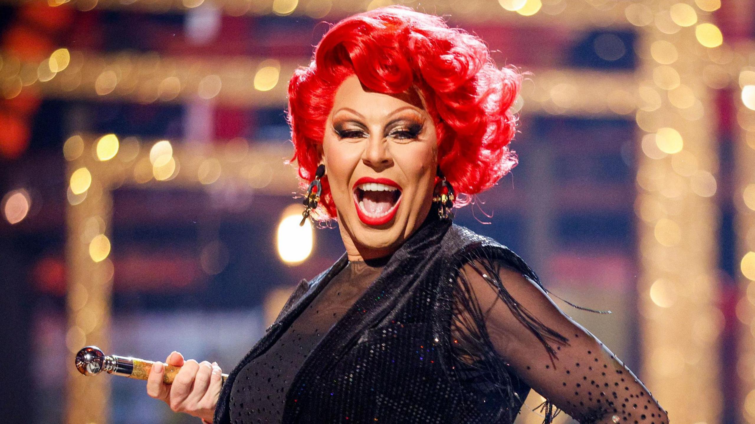 La Voix, pictured dancing with red hair, a glittery black dress and a cane, during a Strictly dress rehersal last weekend