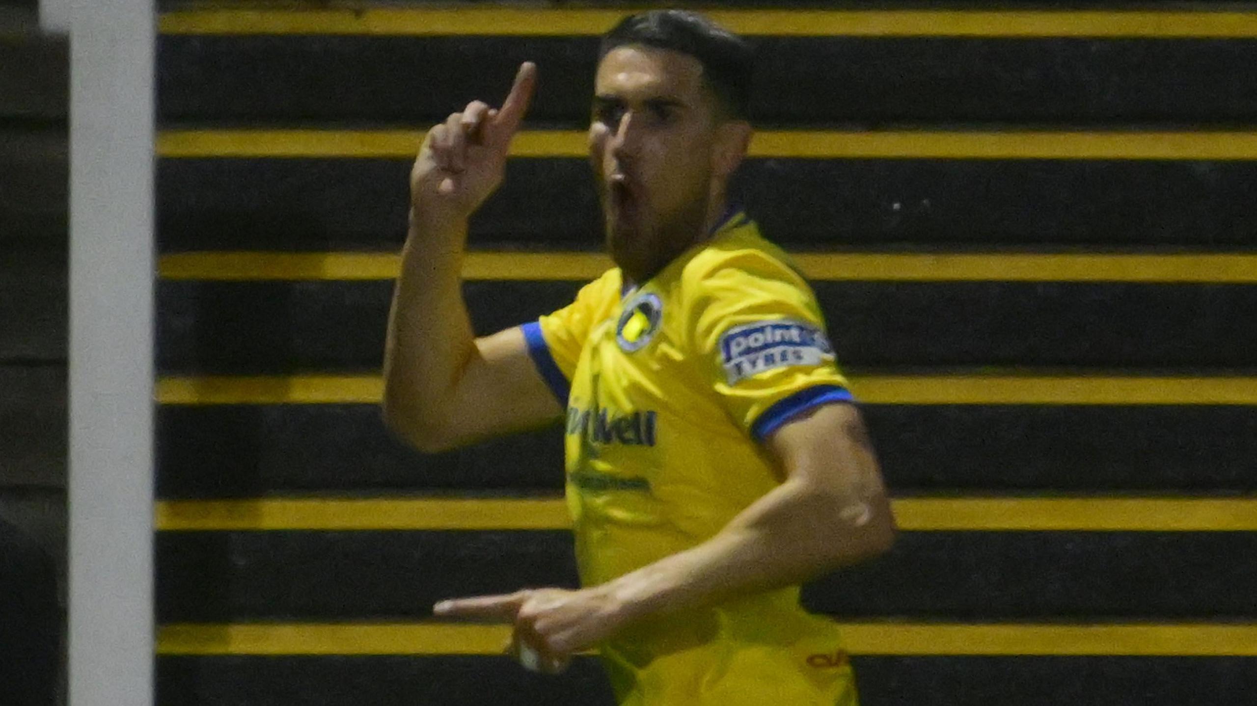 Conor Wilkinson points upwards after scoring a goal for Solihull Moors