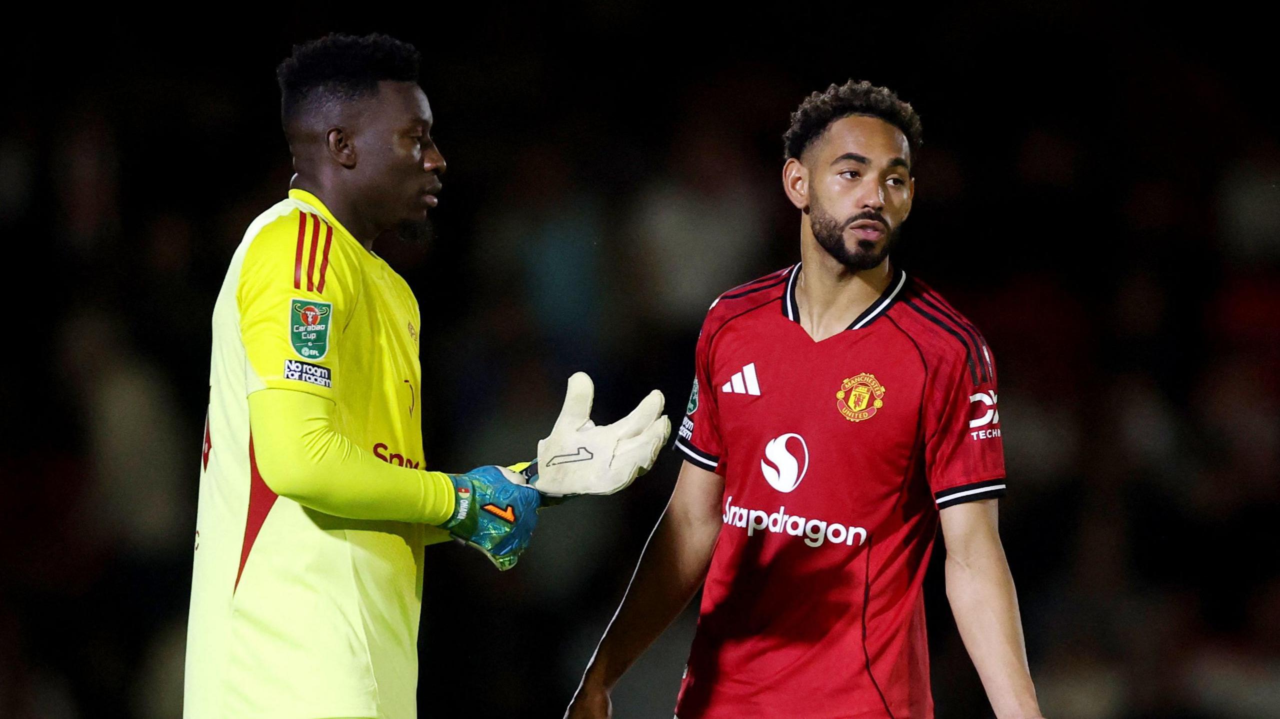 Manchester United's Andre Onana and Matheus Cunha.