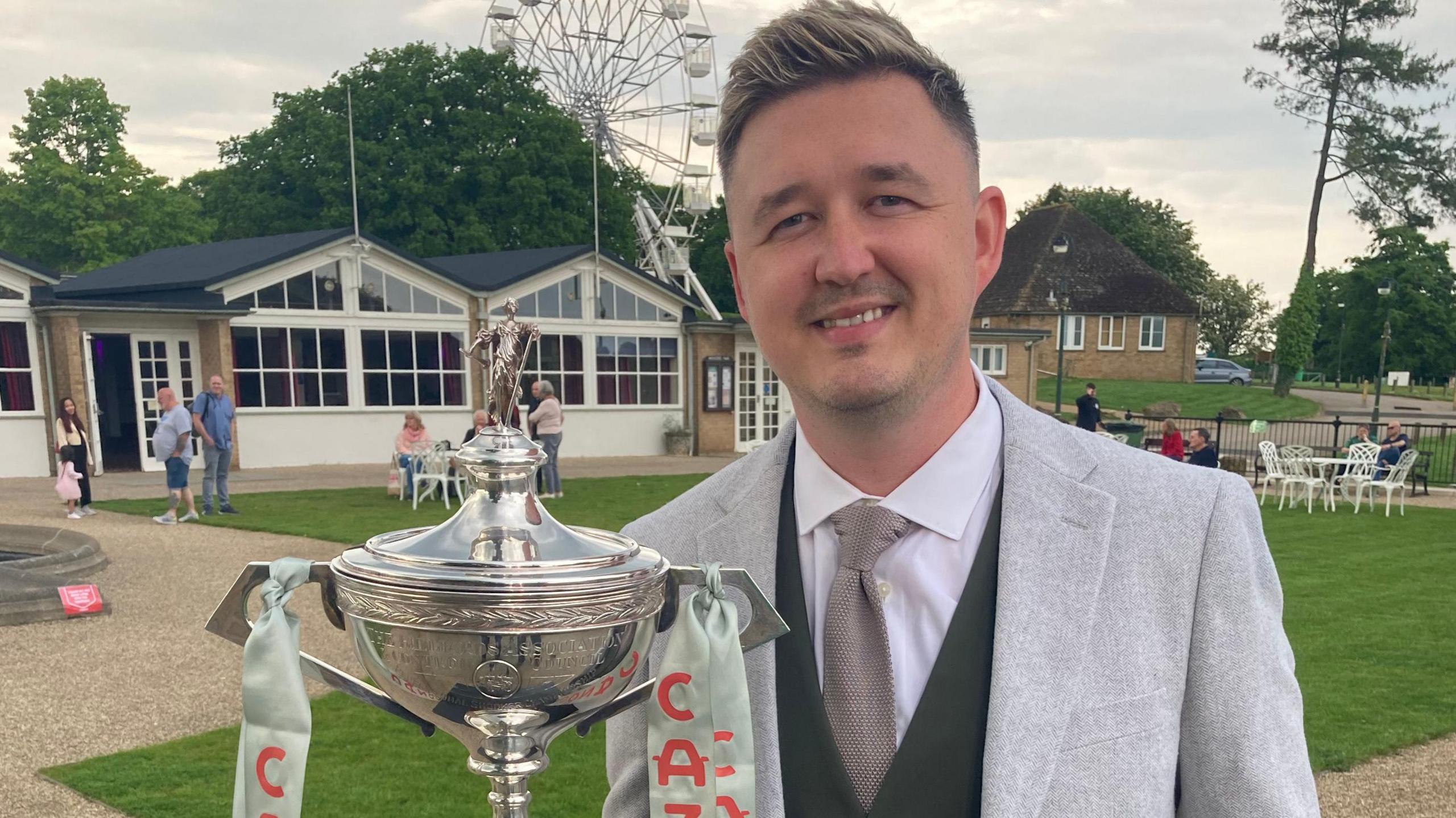 World snooker champion Kyren Wilson, with the trophy, at Wicksteed Park in Kettering