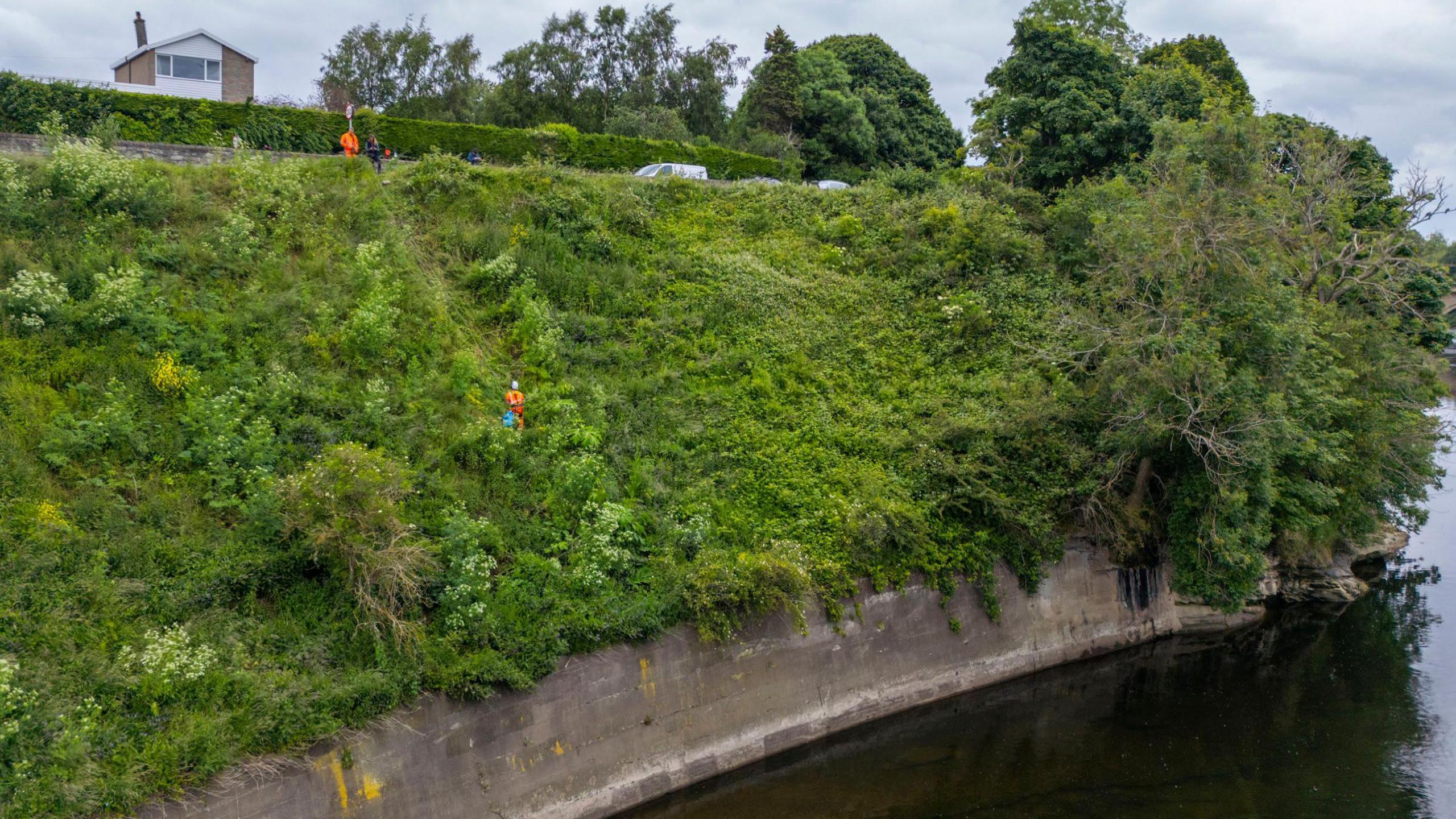 Abseilers on banks of River Tweed