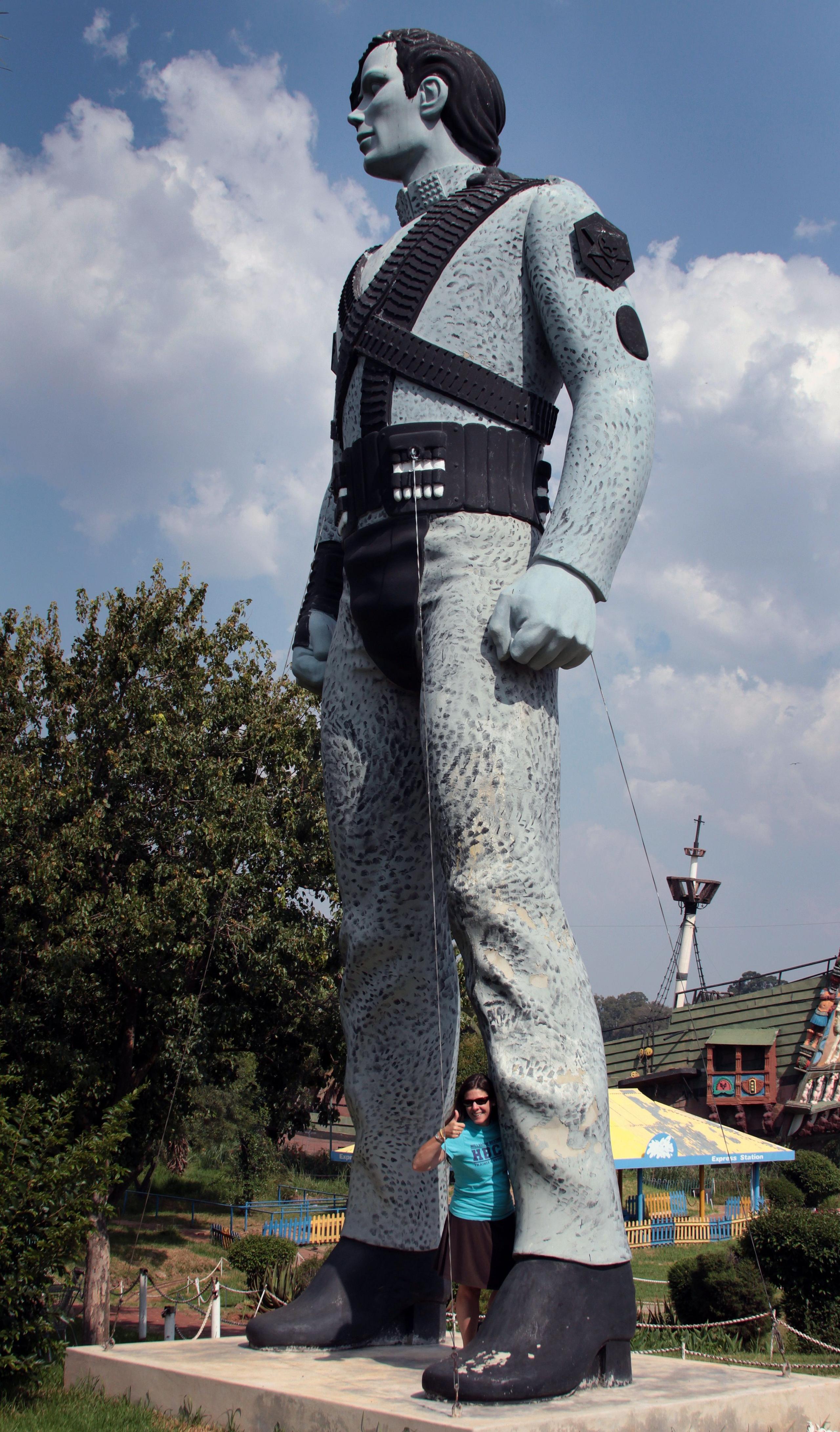 A Michael Jackson statue where parts have been painted black (such as his hair, belts and badges) and the rest is a grey-blue colour.