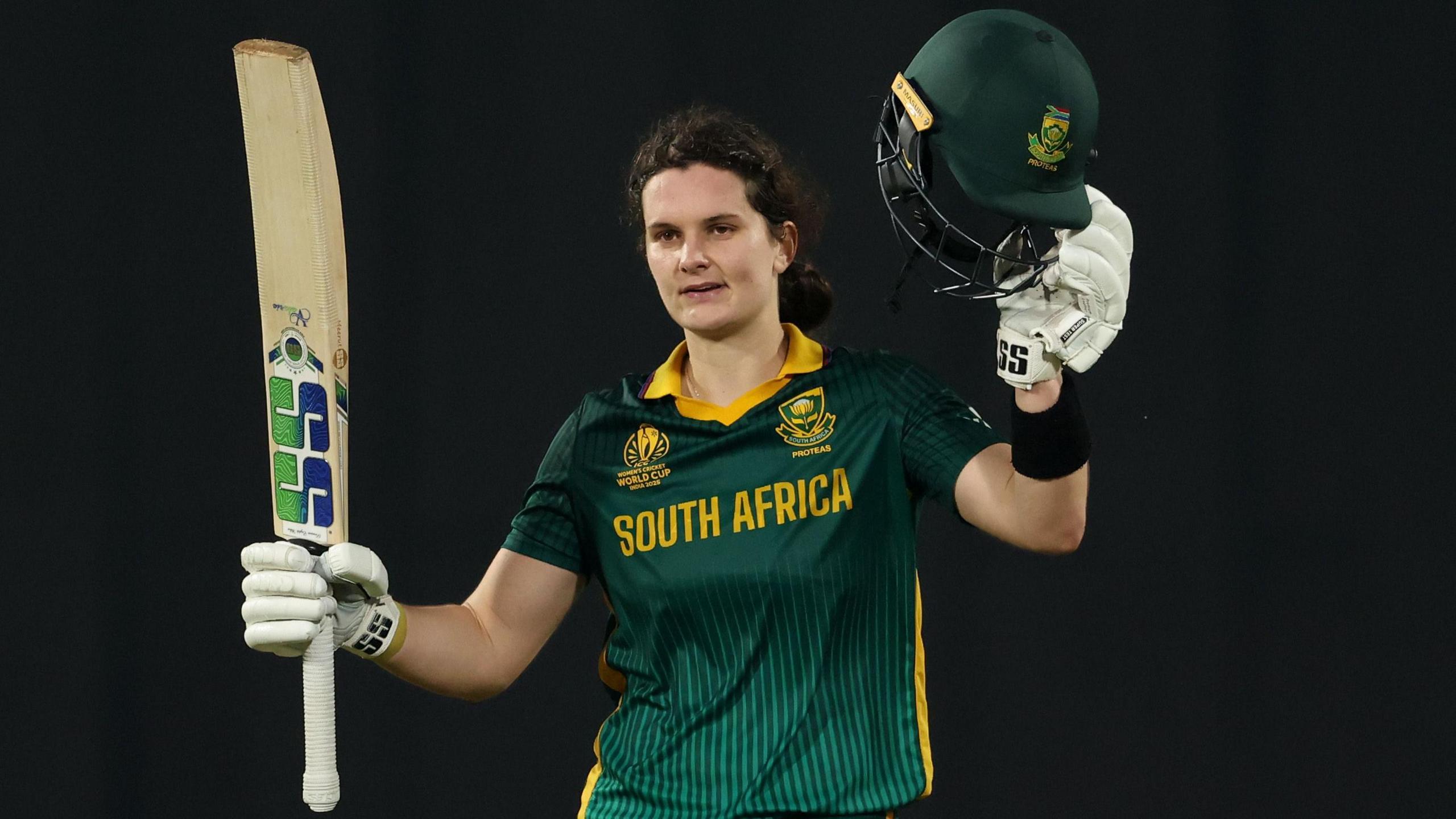 Laura Wolvaardt holds her bat aloft