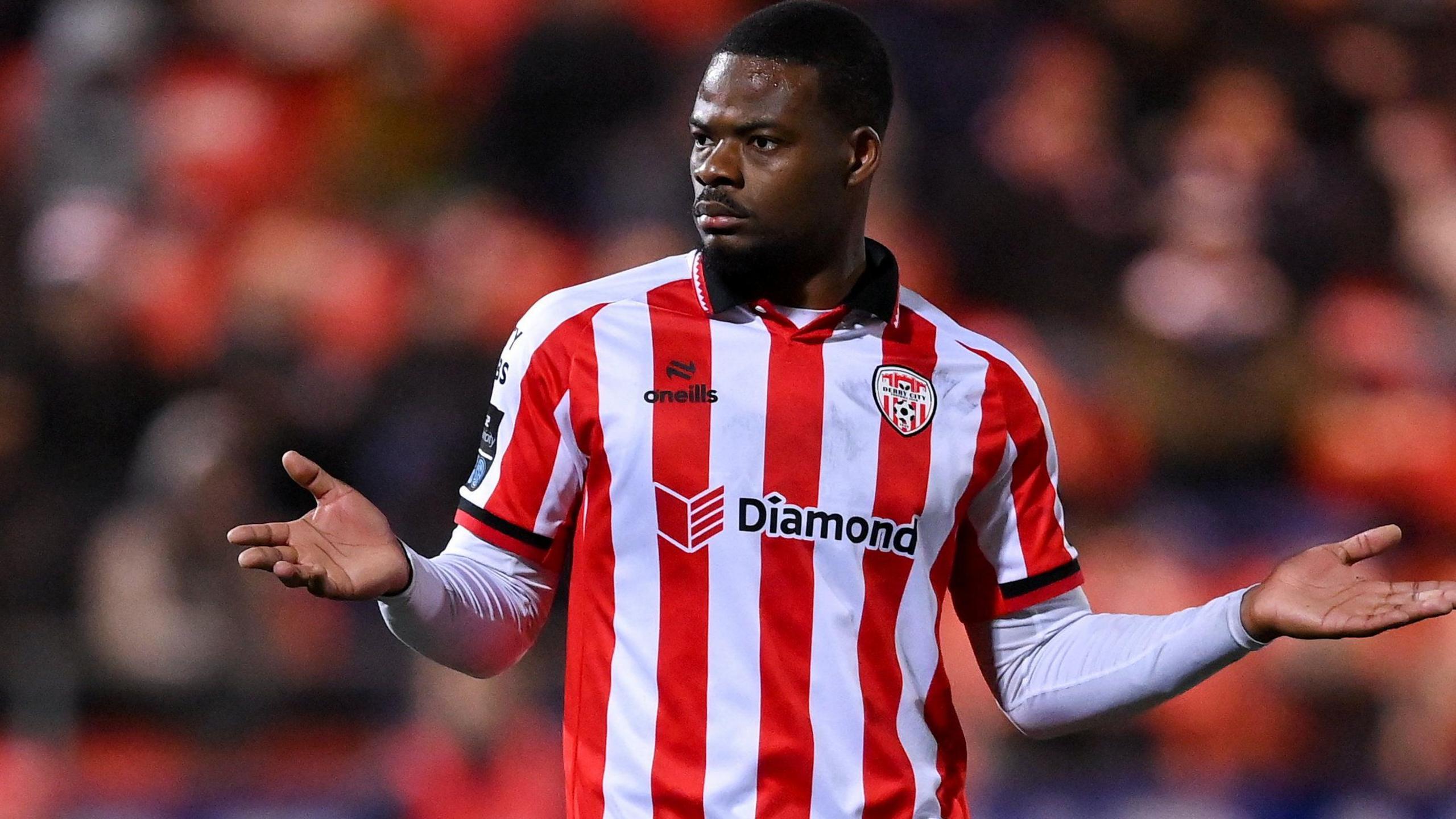 Dipo Akinyemi in action for Derry City in their red and white striped home shirt