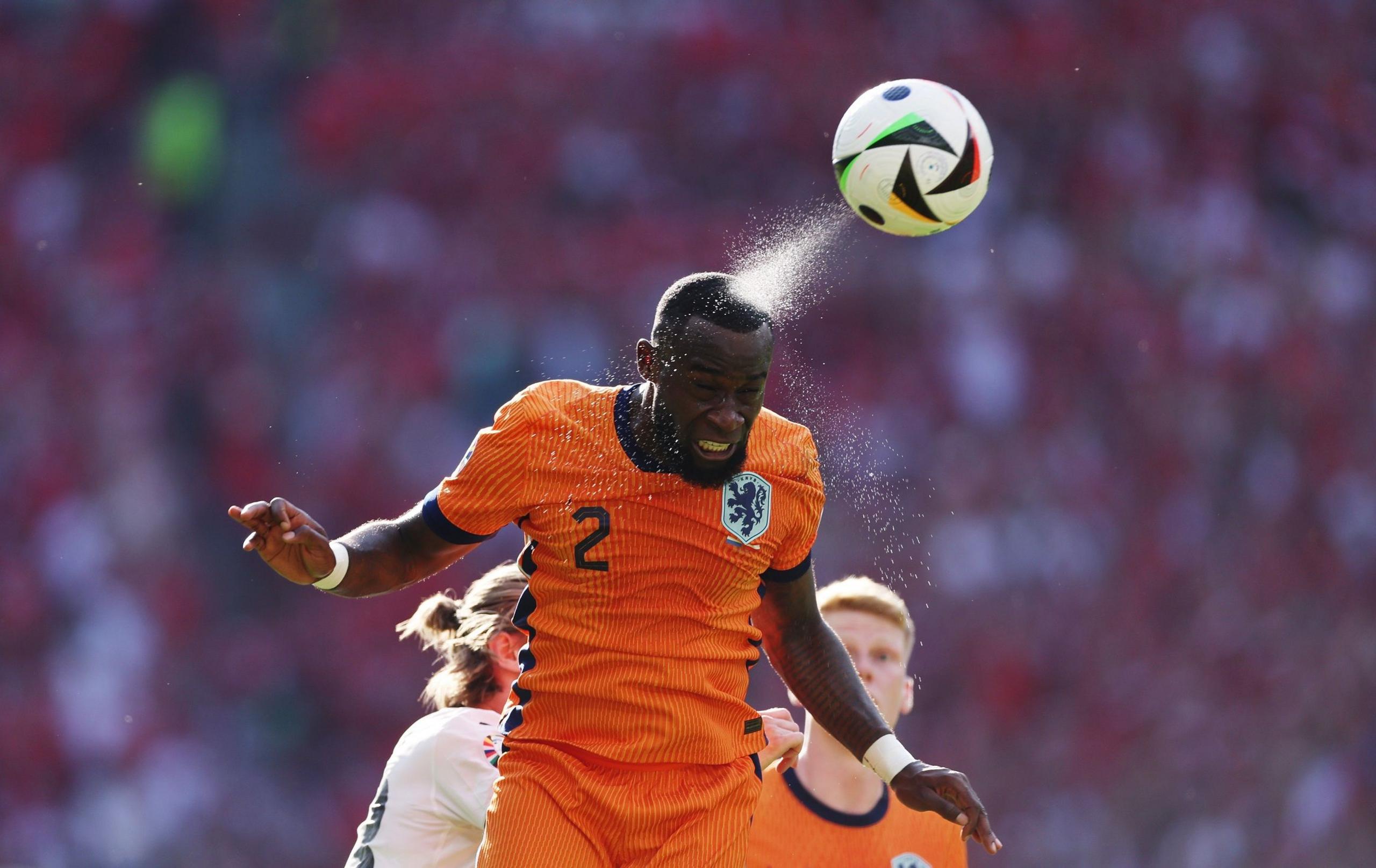 The Netherlands' Lutsharel Geertruida heads the ball in the Euro 2024 group game against Austria