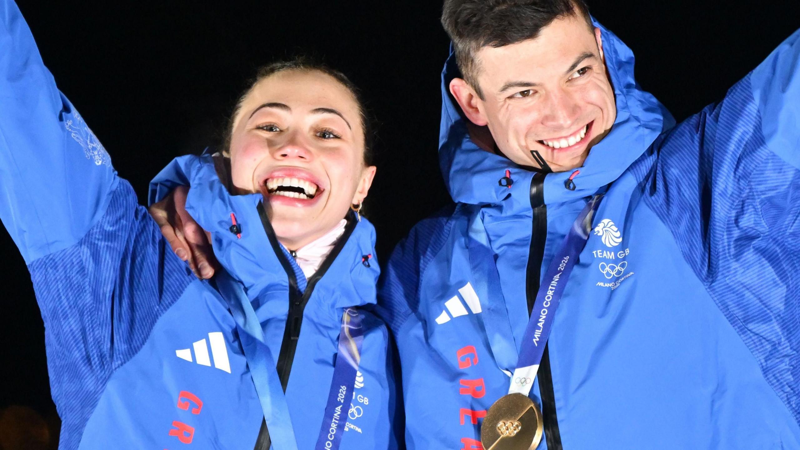 Tabitha Stoecker and Matt Weston waving after getting their medals after winning the Mixed Team Skeleton event. 