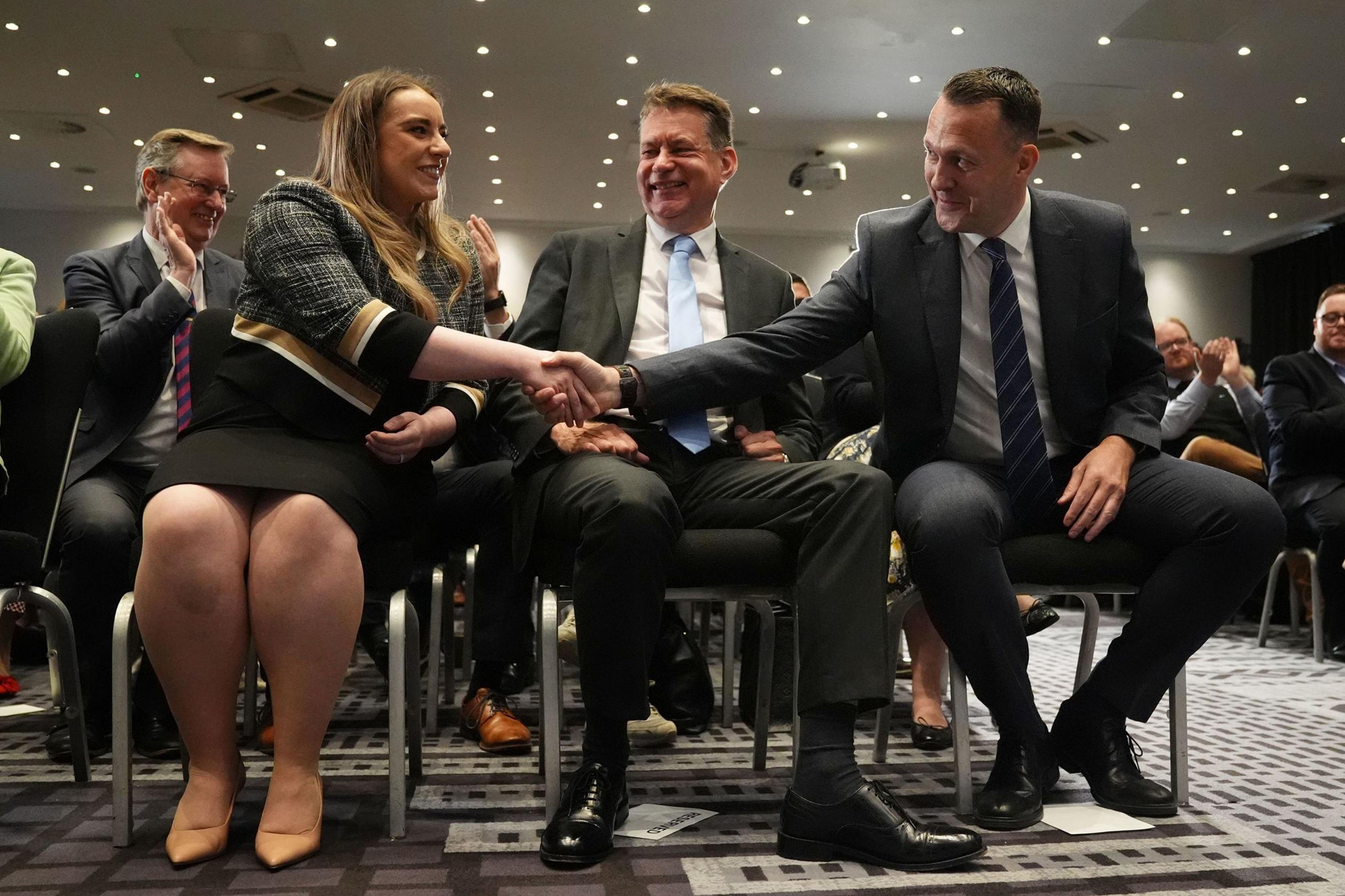 Russell Findlay shakes hands with defeated candidate Meghan Gallacher after the result is announced