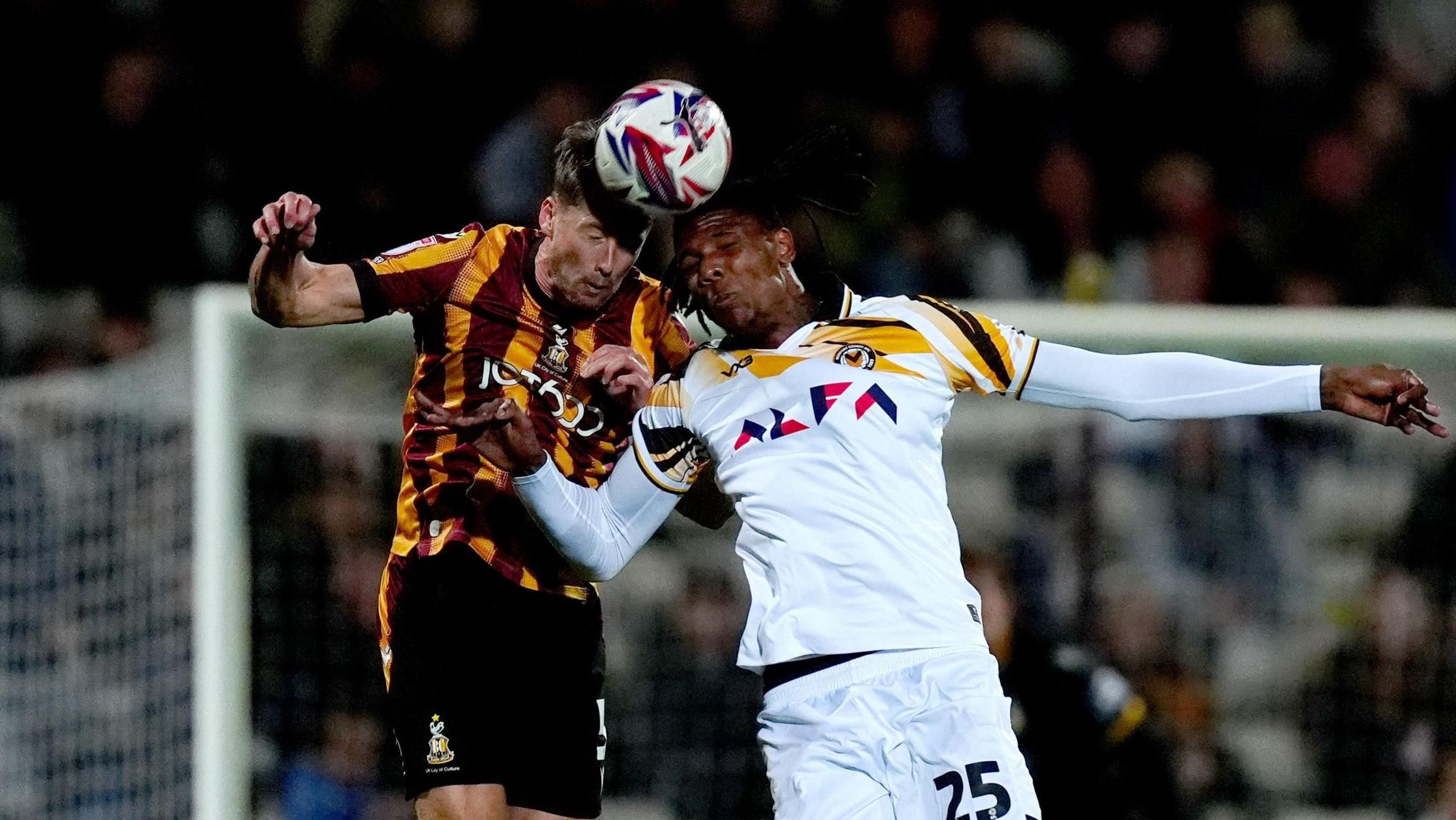 Newport County's Kyle Hudlin battles for the ball against Bradford City's Neill Byrne