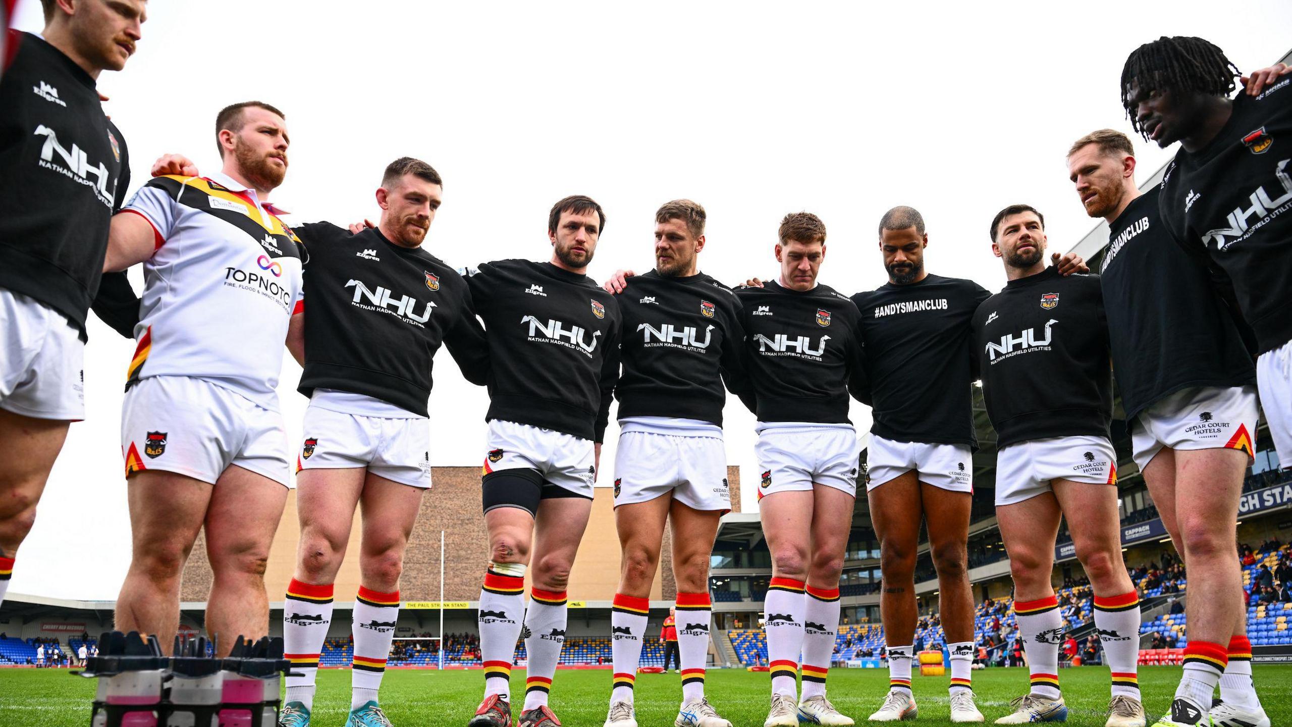 Bradford Bulls players link arms in a huddle before the Challenge Cup tie against London