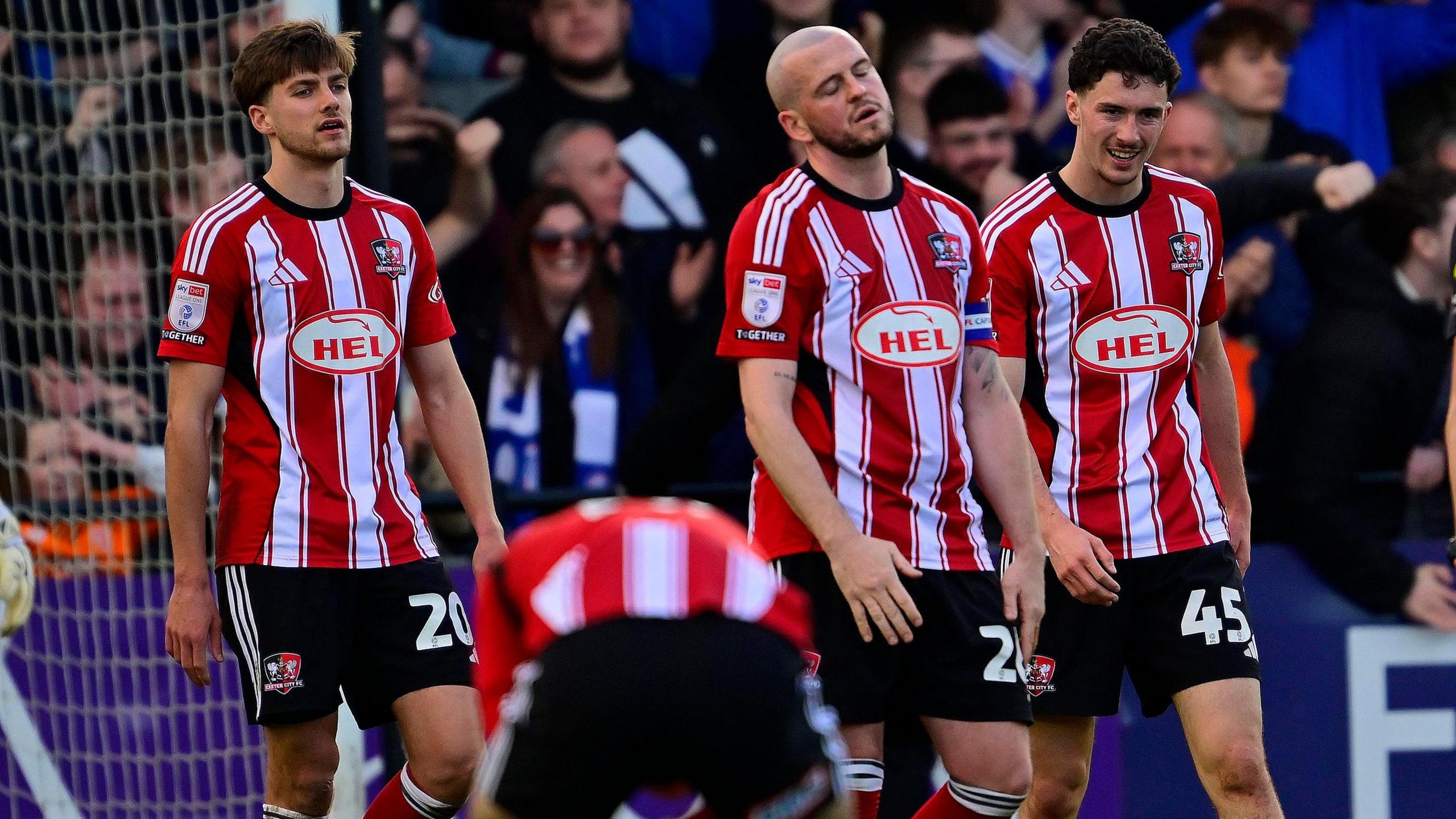 Exeter City players look dejected after conceding against Cardiff City.