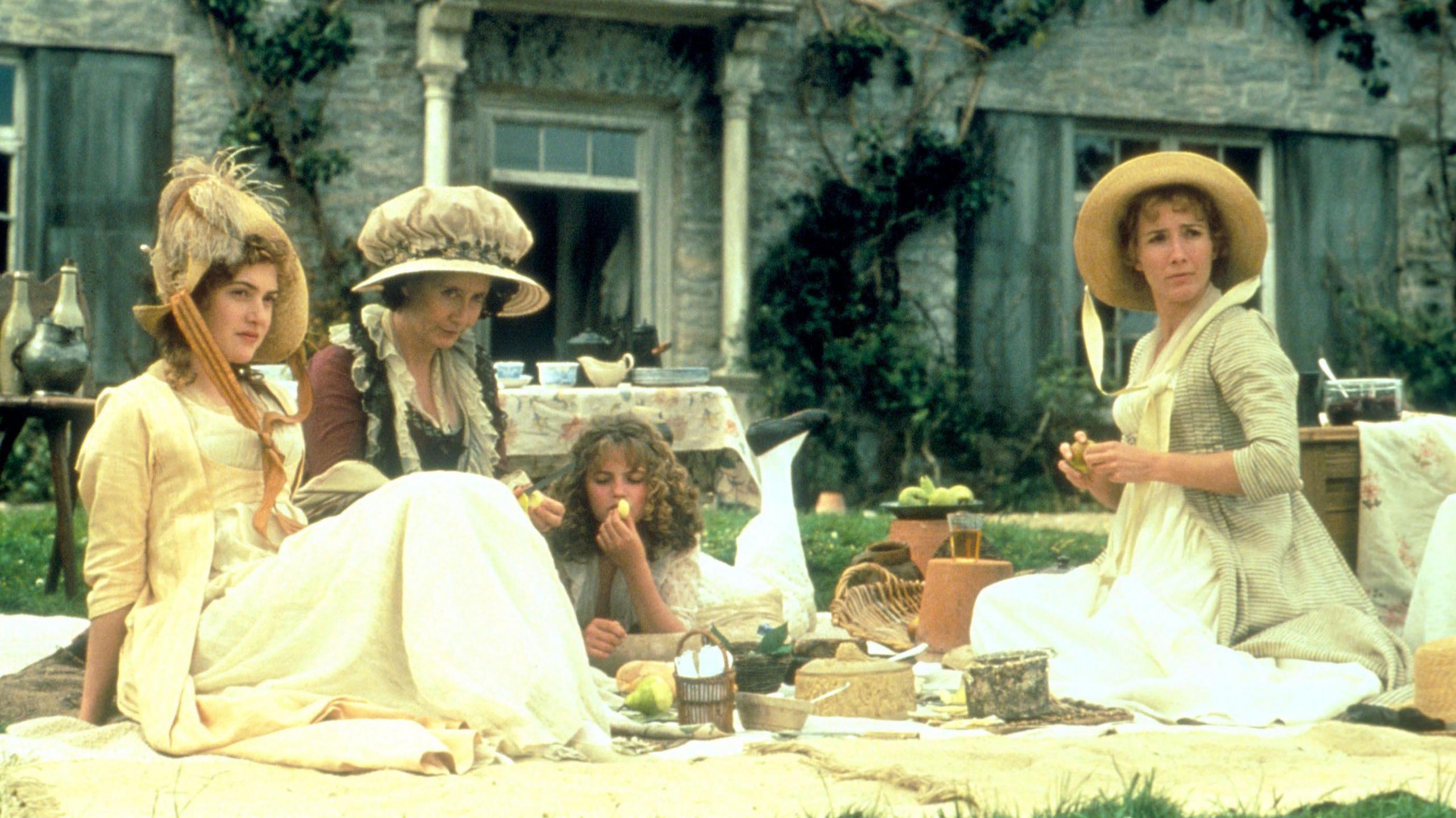 Still from the set of the film Sense and Sensibility in 1995, starring Emma Thompson and Kate Winslet. The actresses are sitting outside, having a picnic.