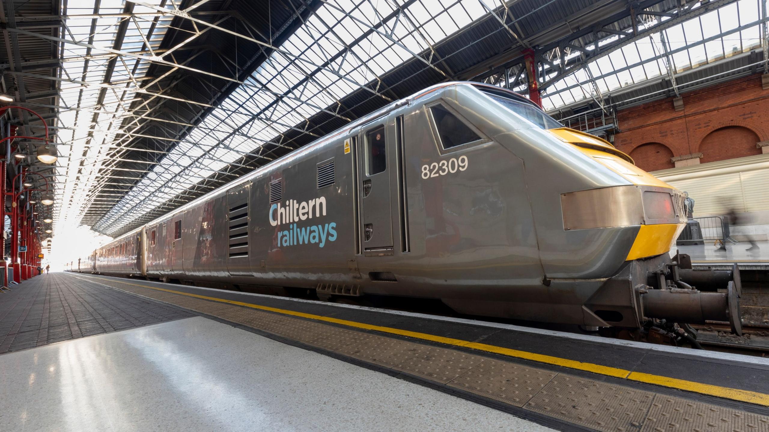 A chiltern railways train stopped at an empty train platform 