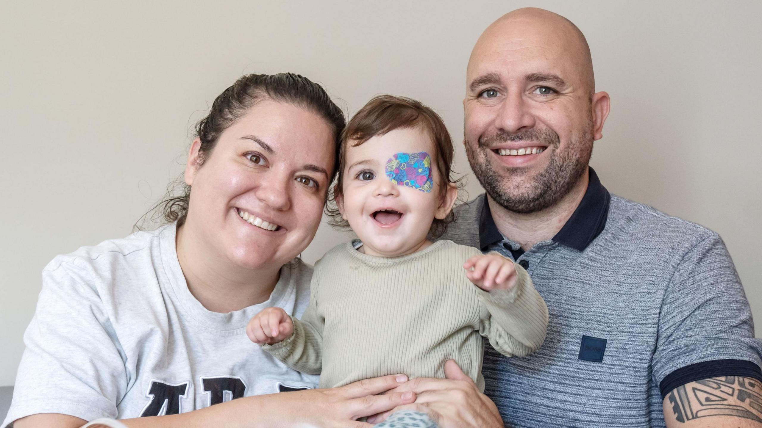 Nuala Mulholland with her mother Megan and father Richard, smiling at the camera 