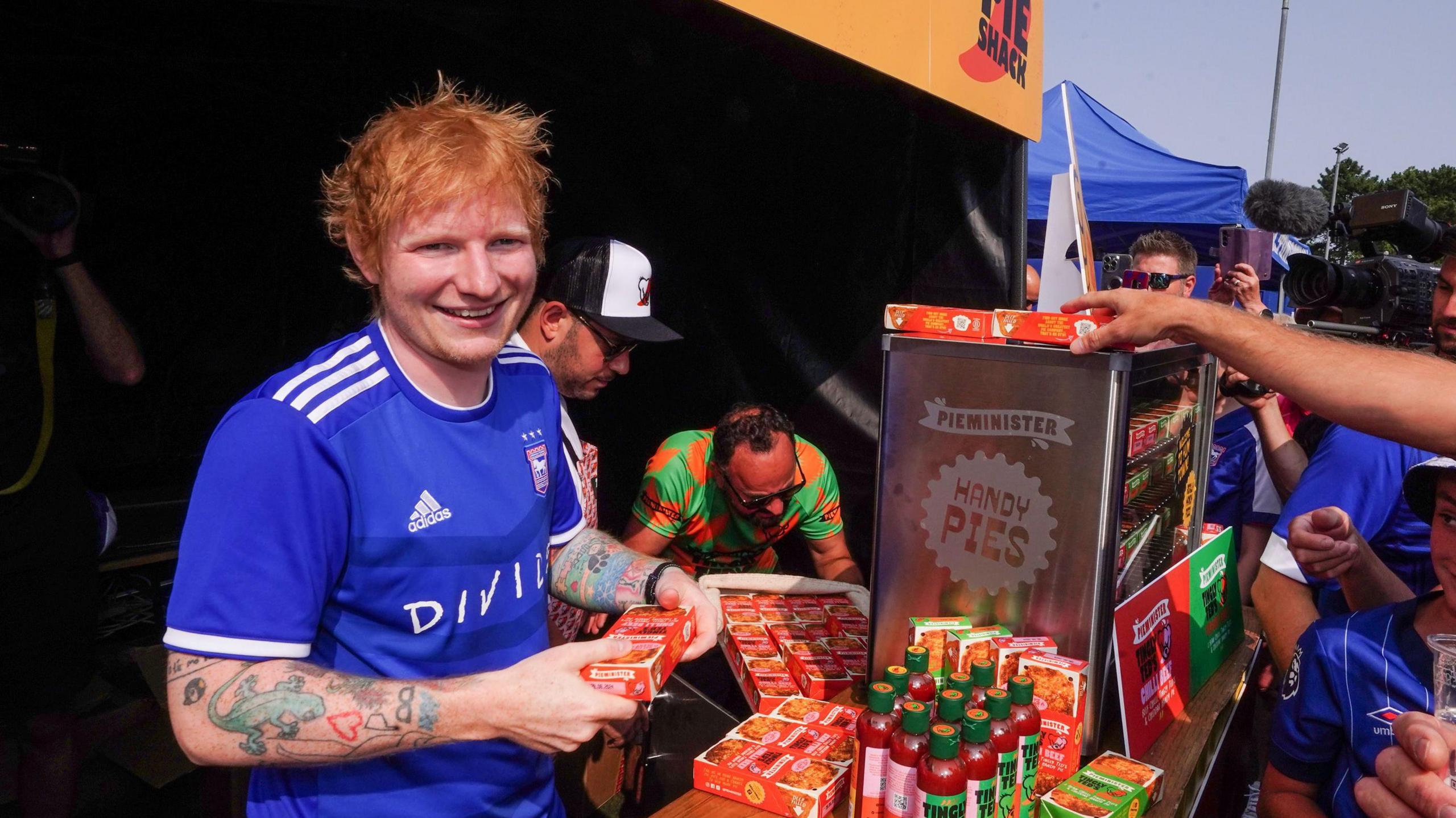 Ed Sheeran handing out hot sauce 