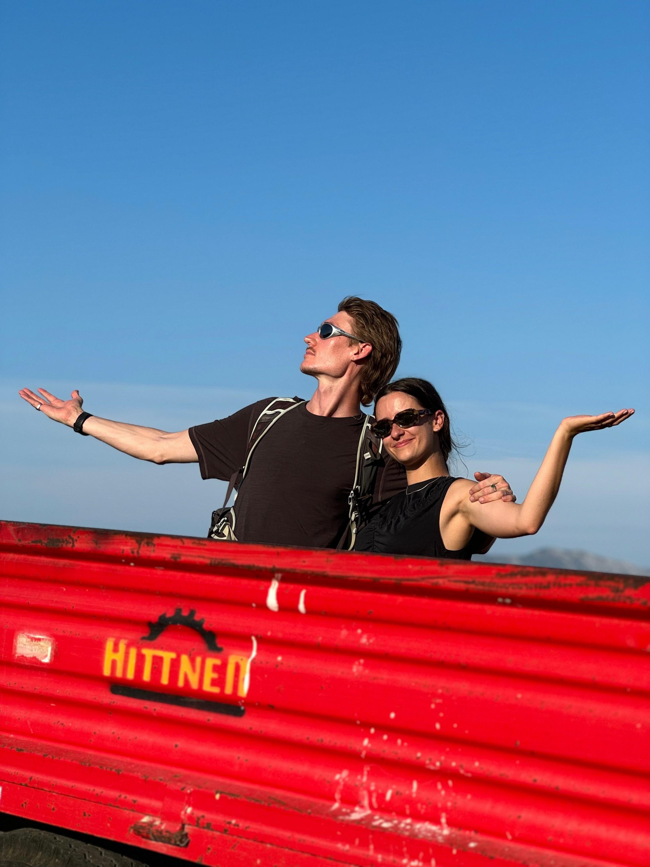 A man and a woman raise their arms