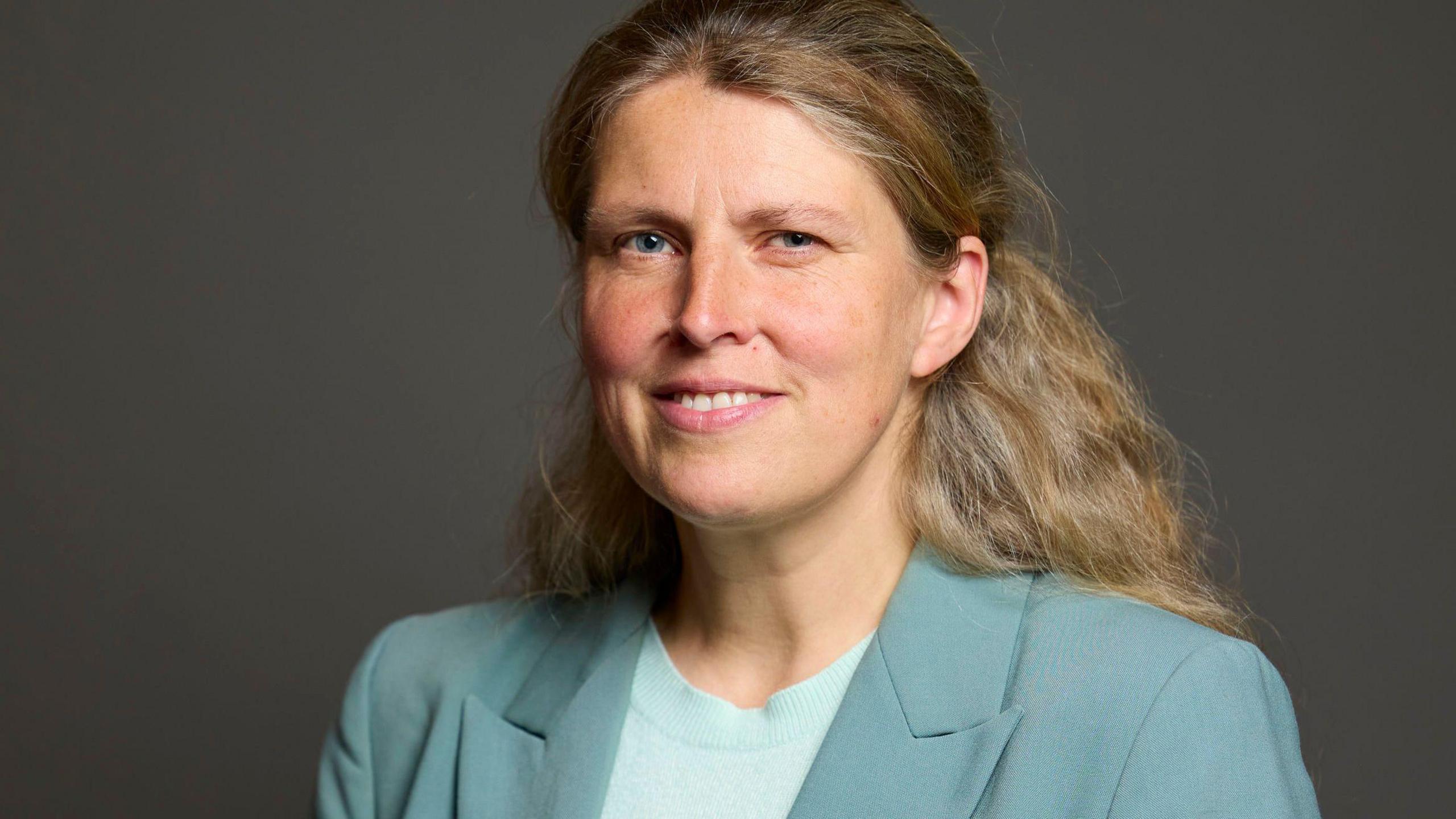 Rachael Maskell MP, pictured in her official Parliament portrait photo. She is wearing a turquoise suit jacket and smiling at the camera.