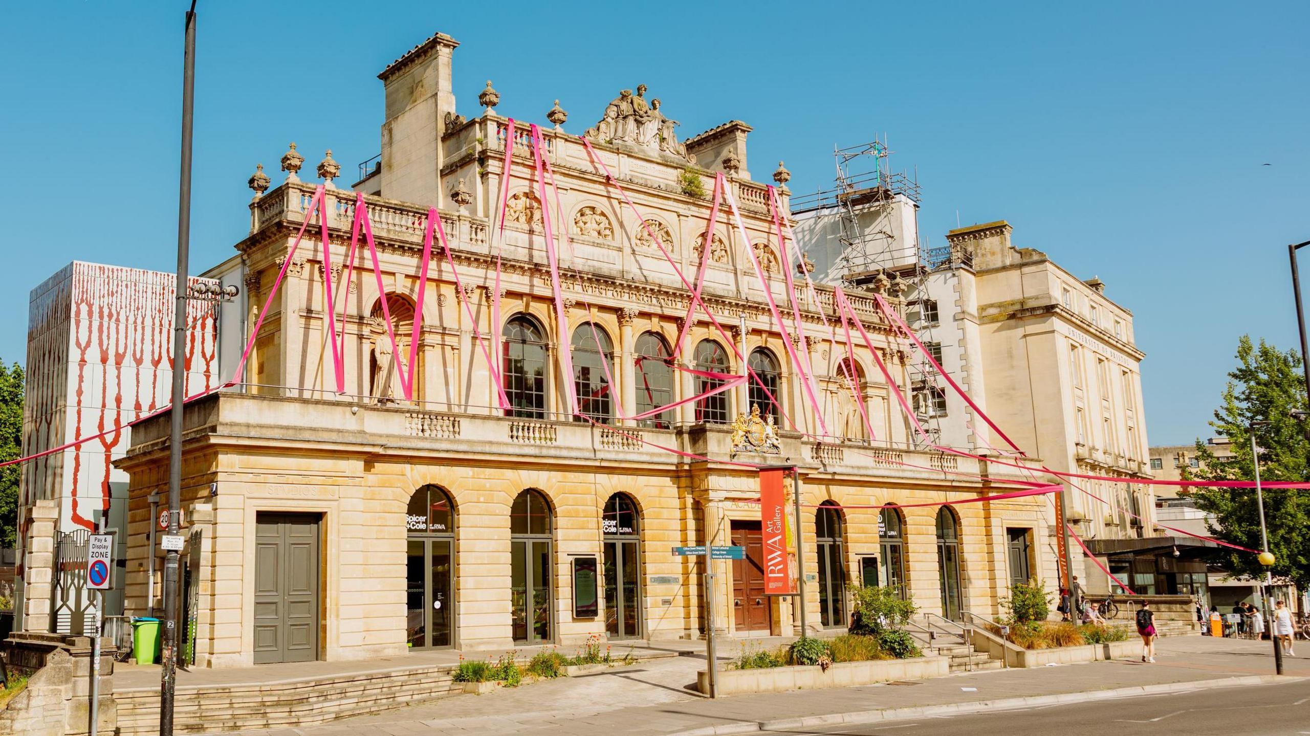Large sections of pink material are seen wrapped around windows and columns of the RWA gallery in Bristol as part of a Luke Jerram artwork