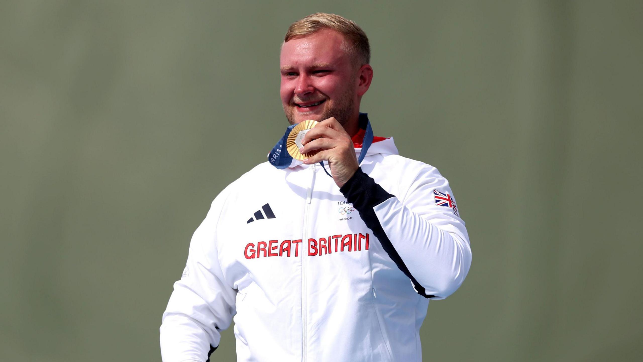 Great Britain's Nathan Hales with his gold medal following the Men's Trap Final at the Chateauroux Shooting Centre on the fourth day of the 2024 Paris Olympic Games in France.