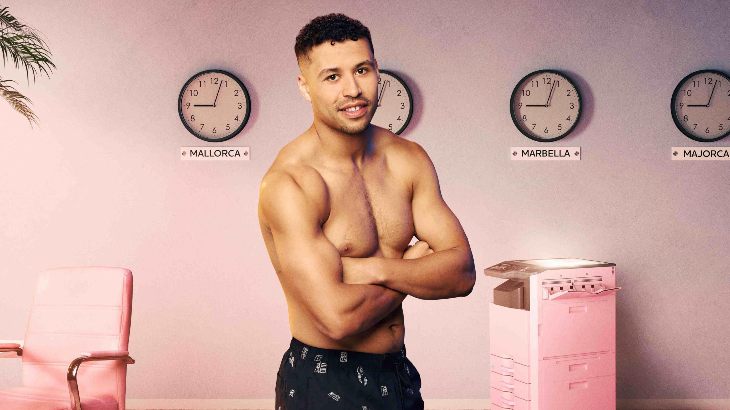 Conor Phillips poses in black swimming trunks with his arms folded. He has short curly brown hair and his image is super imposed on an office-style background complete with pink desk chair and photo copier with four clocks on the wall showing the time in Spanish destinations as just after 9.