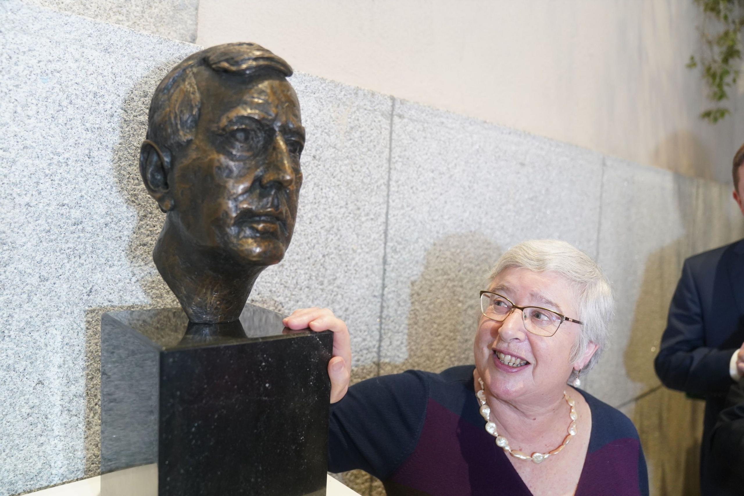 Lord Trimble's widow Daphne stands beside his bust