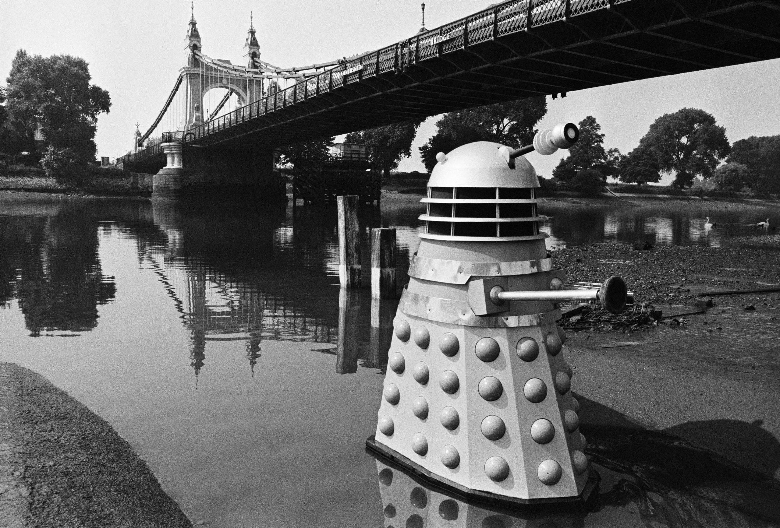 A Dalek emerging from the River Thames near Hammersmith Bridge, as seen in The Dalek Invasion of Earth