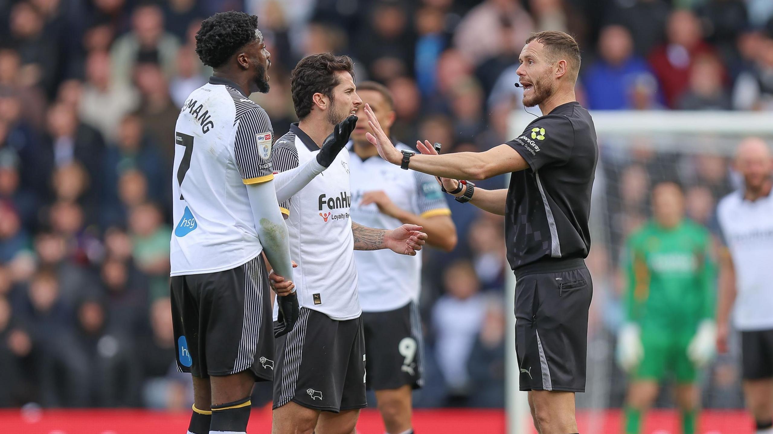 Referee Leigh Doughty tells Derby striker Patrick Agyemang to calm down