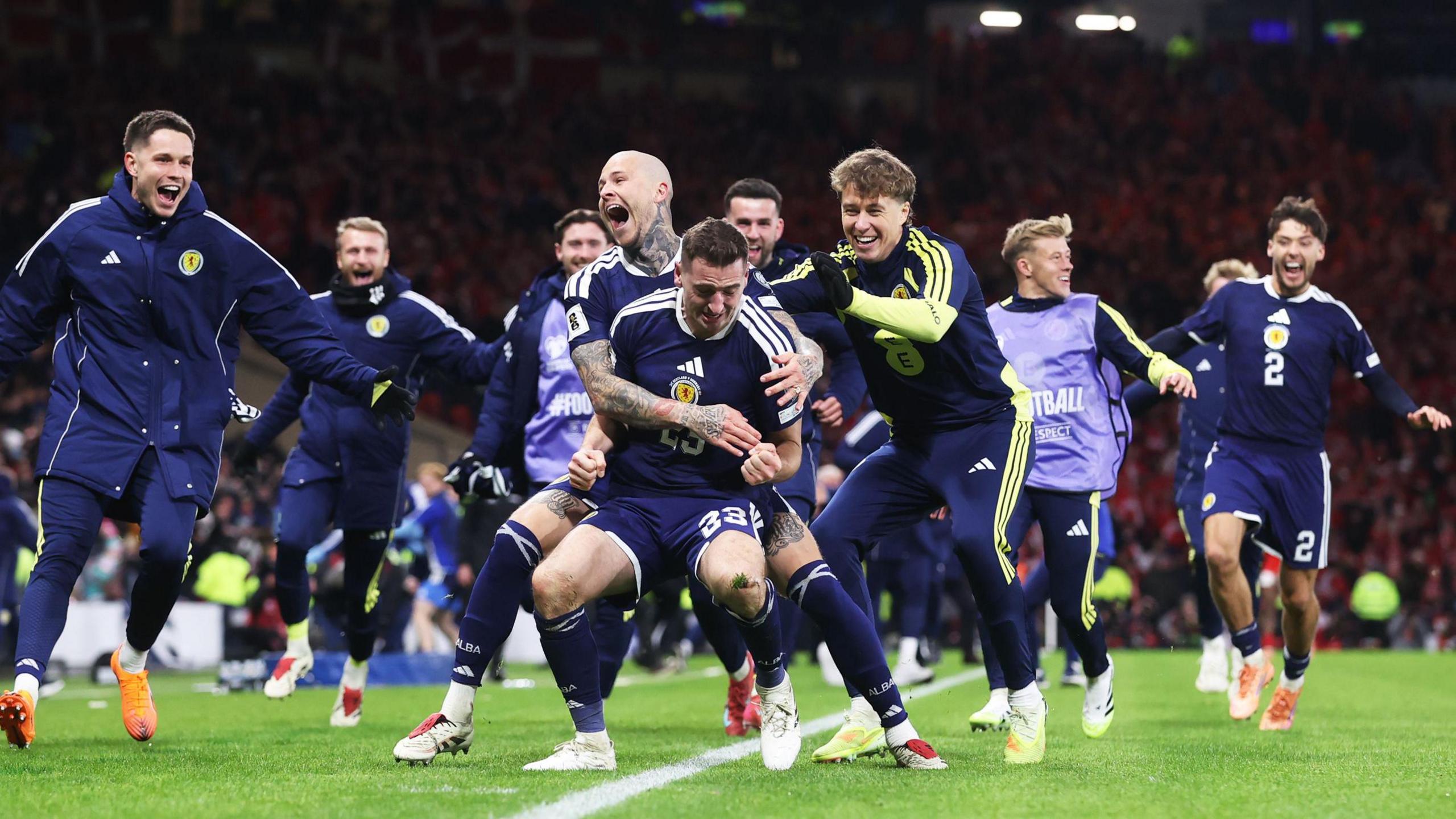 Kenny McLean celebrating with the Scotland players at the end of the match.