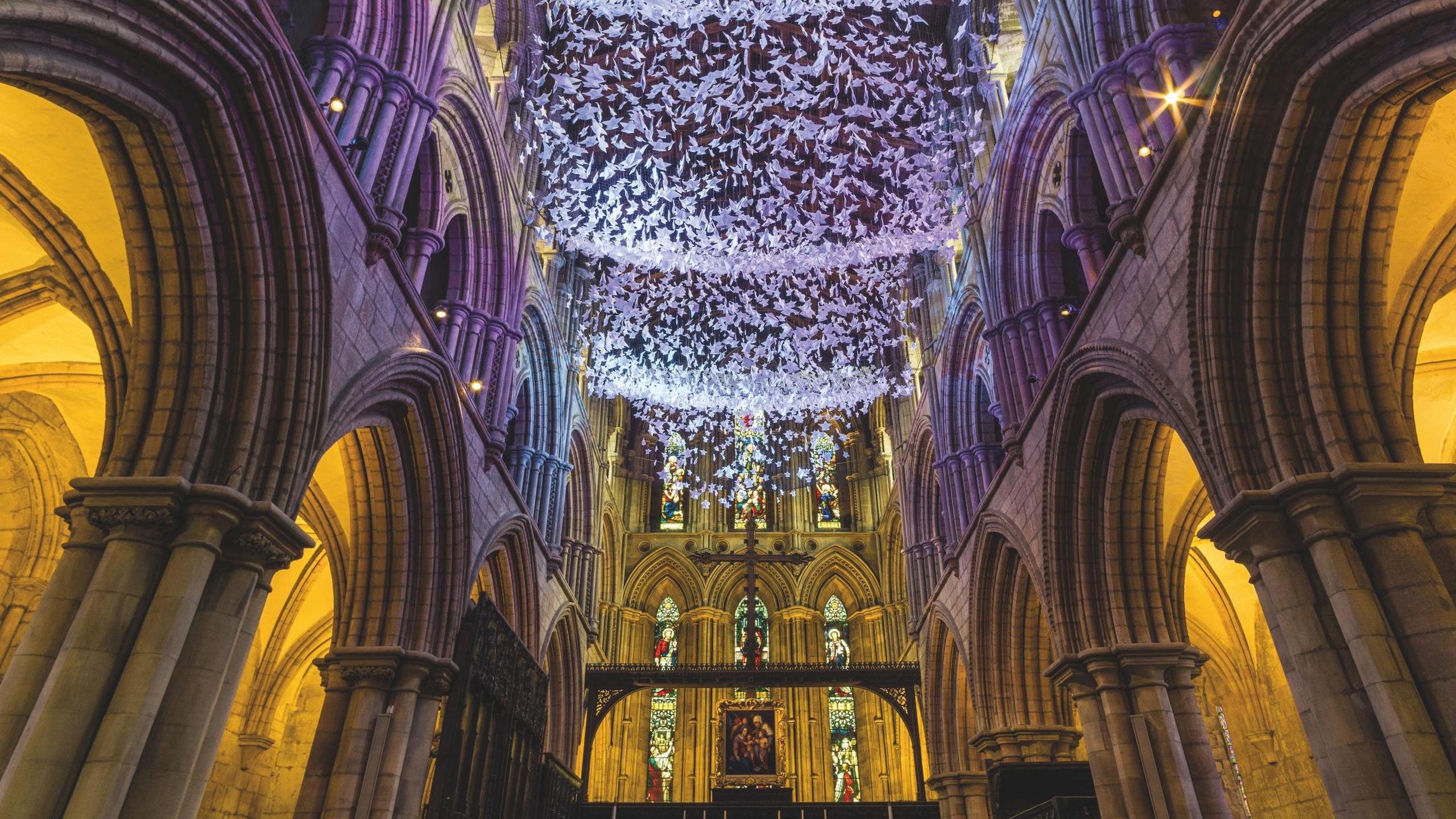 Origami suspended from the ceiling of an abbey. 