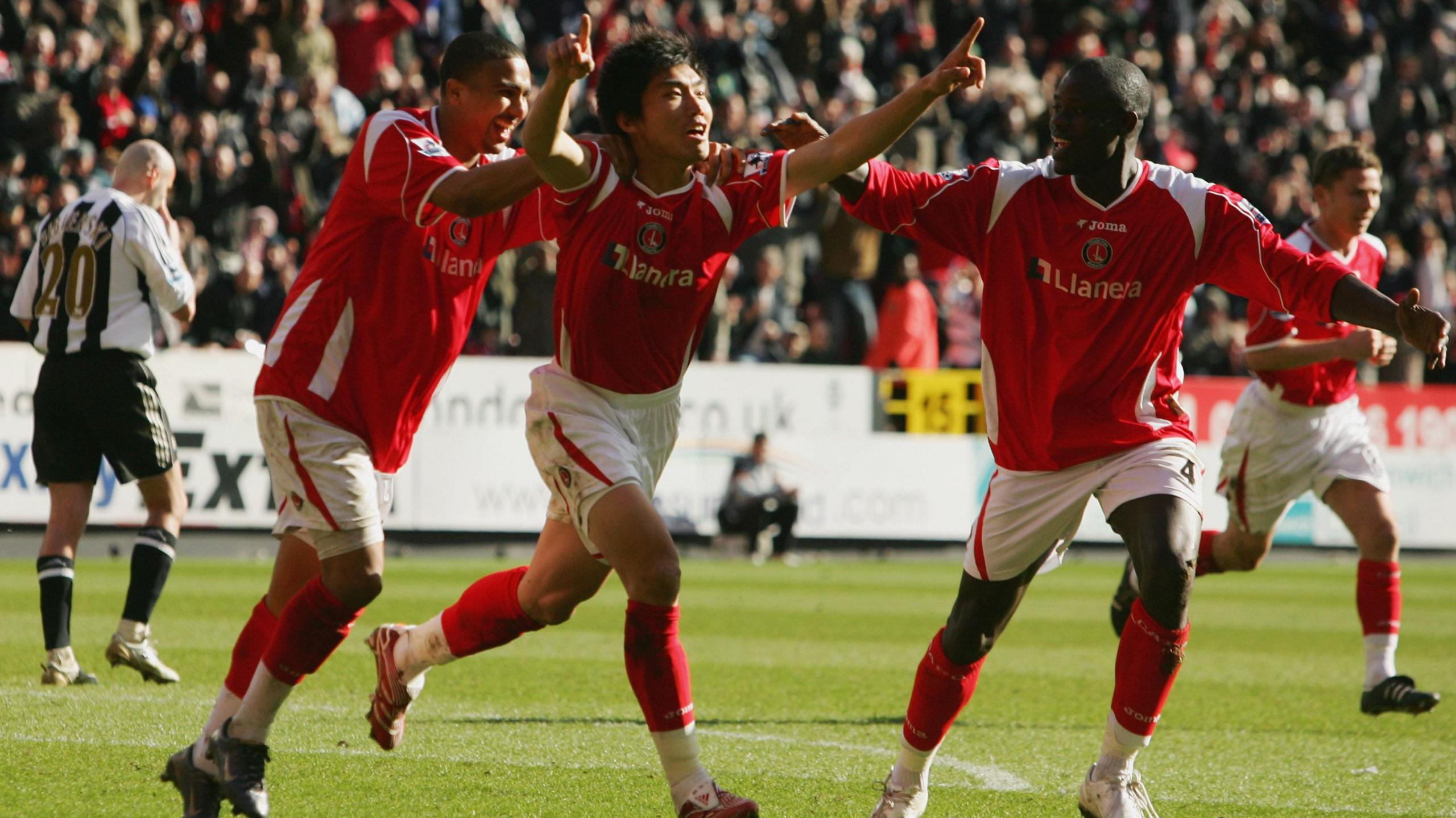 Zheng-Zhi of Charlton Athletic, centre, celebrates as he scores their first goal with team mates Jerome Thomas, left, and Mady Faye, right