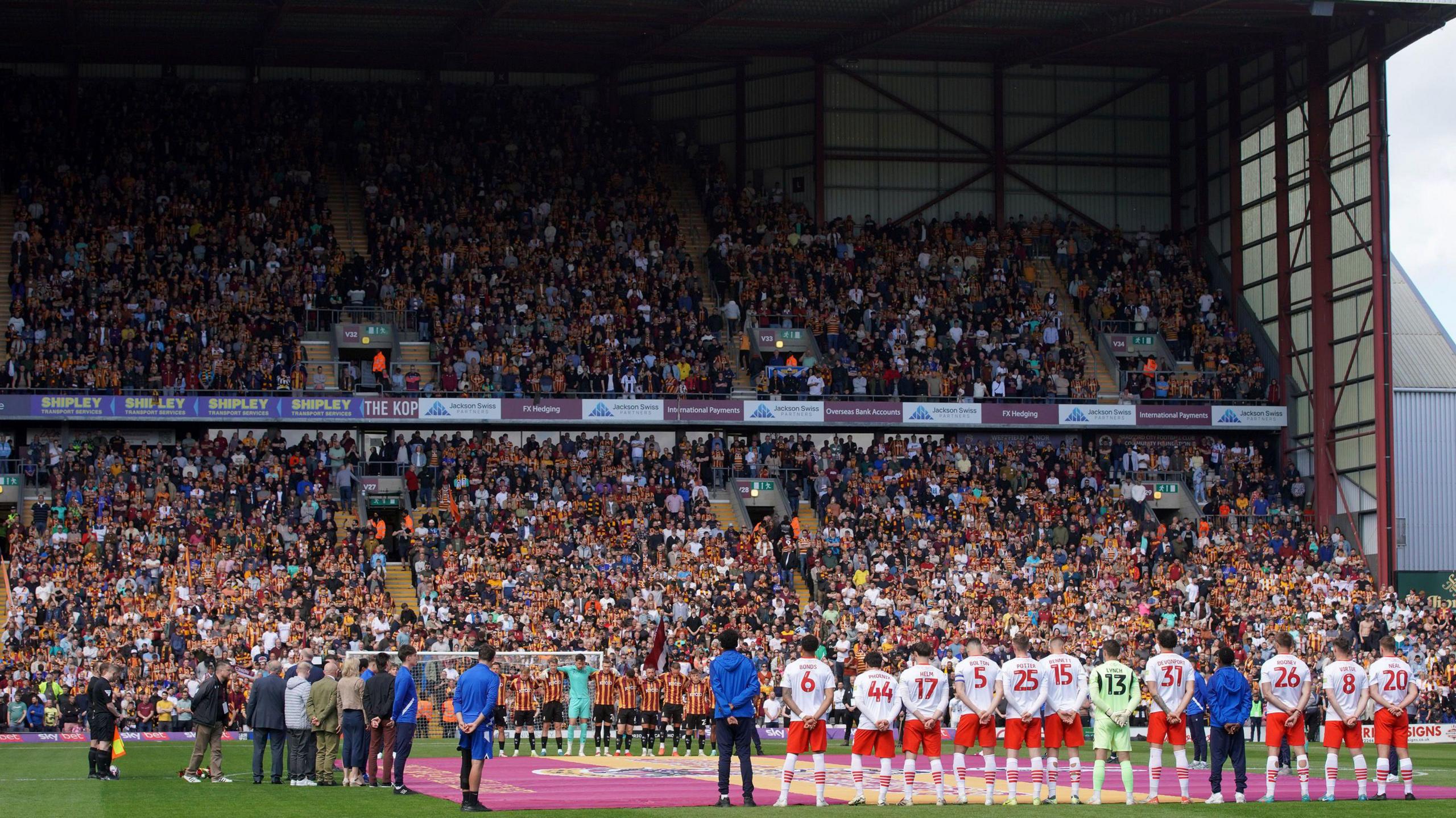 Teams and staff join a minute's silence for victims of the Bradford City fire before the Sky Bet League Two match at the University of Bradford Stadium.