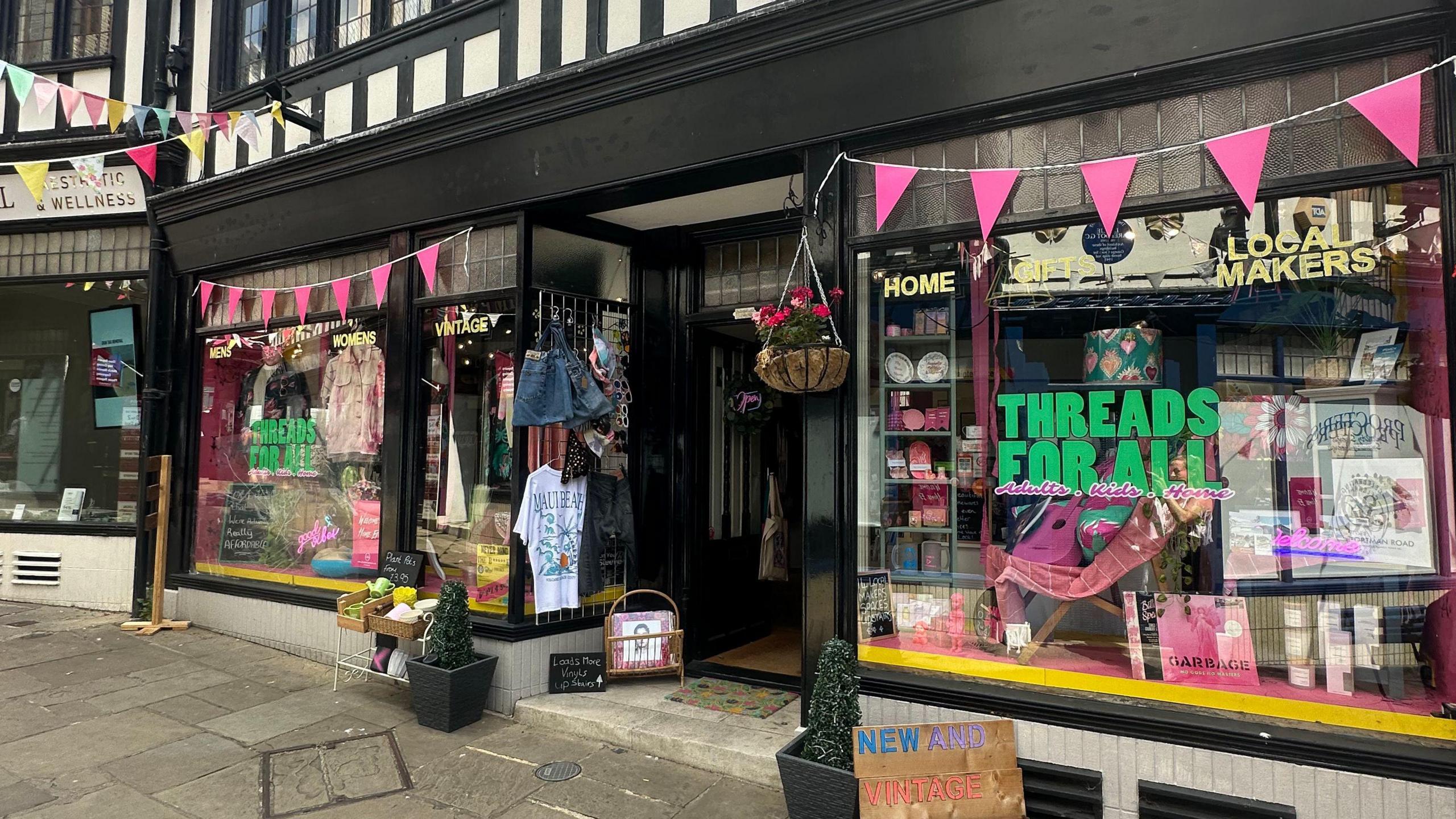 A store front in Ipswich with pink bunting across the top of its windows.